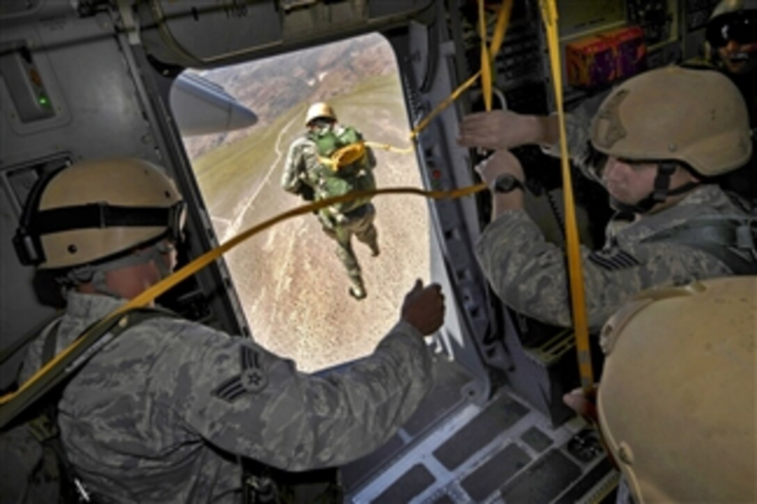 U.S. Air Force airmen jump from a C-17 Globemaster III aircraft during a certification course for drop zone control officers in Alamo, Nev., on May 12, 2011.  The airmen jumpers are assigned to the 820th Rapid Engineer Deployable Heavy Operational Repair Squadron Engineers, also known as the Red Horse Squadron.  Airmen assigned to the 414th Combat Search and Rescue Squadron provided the training.  