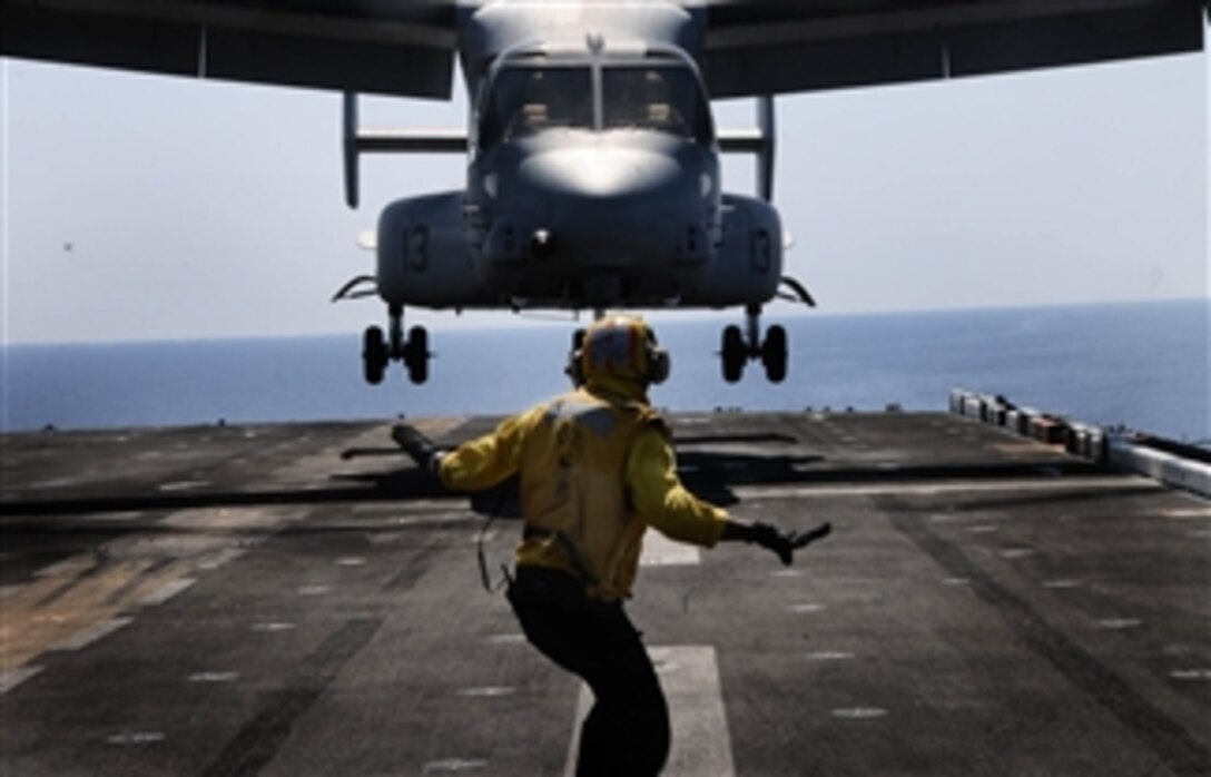 A landing signal enlisted assigned to the multipurpose amphibious assault ship USS Bataan (LHD 5) guides an MV-22B Osprey assigned to Marine Medium Tiltrotor Squadron 263 (Reinforced), 22nd Marine Expeditionary Unit, onto the flight deck underway in the Mediterranean Sea on May 16, 2011.  The Bataan is the command ship of the Bataan Amphibious Ready Group and is conducting maritime security operations and theater security cooperation efforts in the U.S. 6th Fleet area of responsibility.  