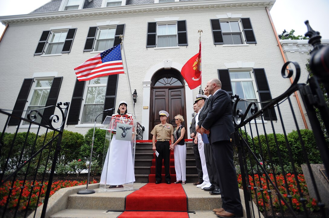 Staff Sgt. Sara Dell'Omo sings at the Home of the Commandants ribbon cutting ceremony at Marine Barracks Washington May 20. Gen. James Amos, commandant of the Marine Corps, and his wife invited local neighbors to visit the inside of the renovated home. The consturction on the house has been ongoing since Amos's change of command ceremony in October 2010.