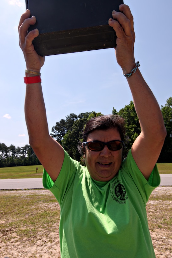 CAMP GEIGER, N.C.—Bea Campbell, mother of Staff Sgt. Bella Damaske, platoon commander with Company H, Marine Combat Training Battalion, School of Infantry-East, performs ammo-can lifts during the modified combat fitness test activity at SOI-East’s Jane Wayne Day, May 21.  This year’s Jane Wayne Day included many different activities for family members to see what their Marines do on a daily basis.