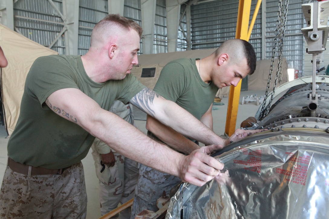 Sgt. Cody Coster and Sgt. Michael Bergman, both aircraft mechanics with Marine Fighter Attack Squadron 122, load an F/A-18 Hornet engine into a preservation container to be sent back to Marine Corps Air Station Beaufort, S.C., May 21. VMFA-122 will soon depart Afghanistan following a seven month deployment providing close air support for U.S. Marines, and Afghan, British, Georgian and other combined team forces operating in Nimroz and Helmand provinces.