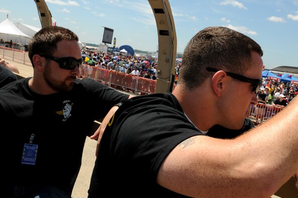 JOINT BASE ANDREWS, Md. -- Marine Lance Cpl. Eli Tice (right) and brother Alex Tice wave to the crowd aboard a M-35 Deuce and a Half belonging to the Wounded Warrior Flight Team during the Joint Service Open House here May 21, 2011. Corporal Tice and soon Alex, will be taking part in a flight training program sponsored and paid for by the WWFT. The WWFT is a charitable organization that helps wounded veterans obtain vocational training and eventually earn full time employment. The WWFT travels to military events like the JSOH in order to spread awareness and gain support for it's Wounded Warroir job training programs. (U.S. Air Force photo/Tech Sgt.Steve Lewis)