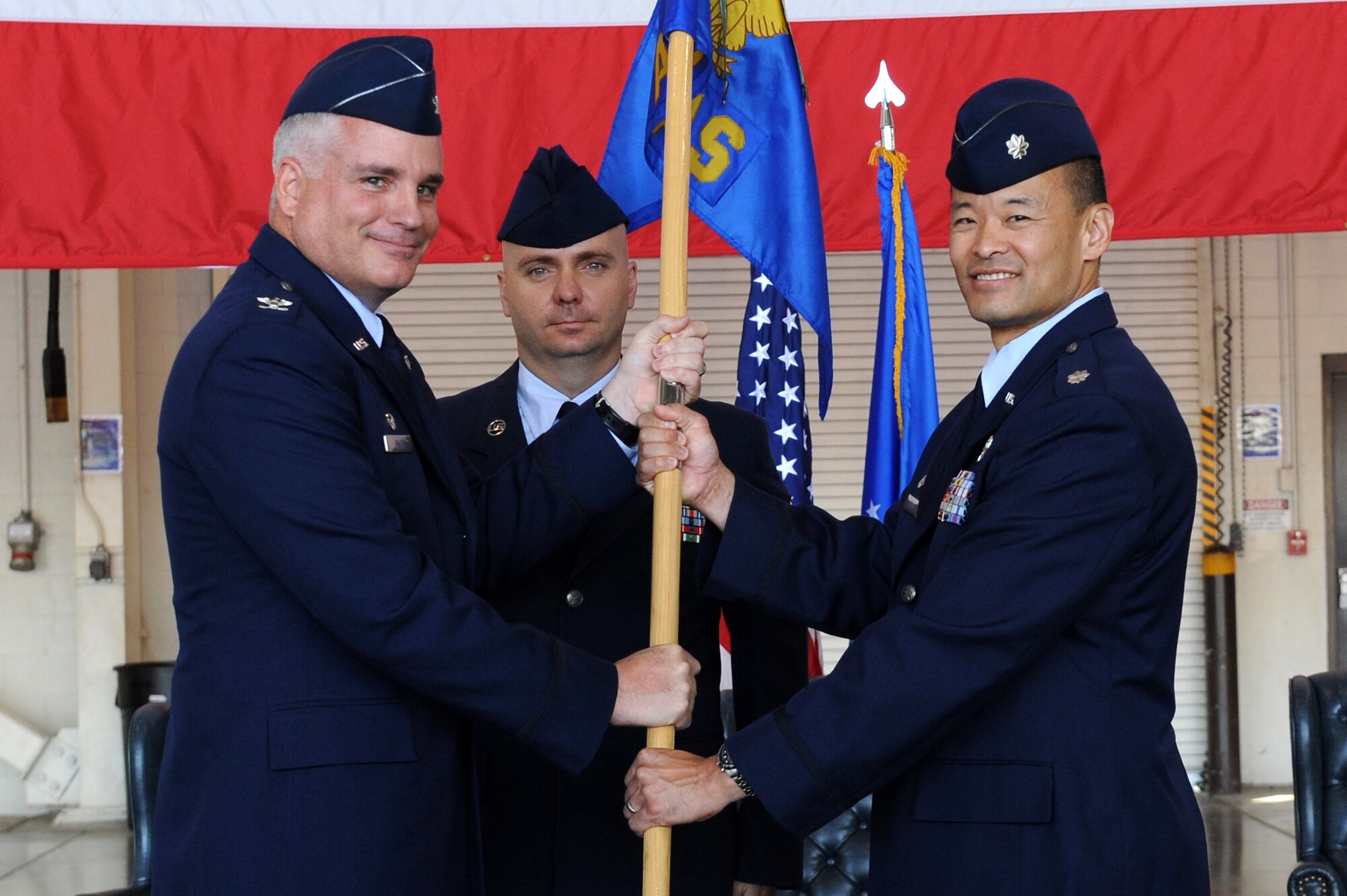 Lt. Col. Michael Honma (right), incoming 48th Airlift Squadron commander, accepts the guidon from Col. Michael Bauer, 314th Operations Group commander, and as such, command of the unit May 13, 2011, at Little Rock Air Force Base, Ark. The 48th AS is the only squadron allowed to formally train Airmen and foreign students on C-130 J models. (U.S. Air Force photo/Airman 1st Class Ellora Stewart)