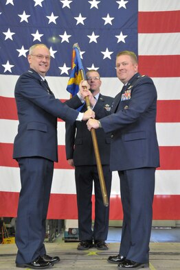 Col. David A. Kasberg, 19th Operations Group commander, passes the 30th Airlift Squadron's guidon to Lt. Col. Rodney L. Simpson, the unit's new commander, during the change of command ceremony May 13, 2011, at Cheyenne Regional Airport, Wyo. The 30th AS is an active associate flying squadron that partners 19th Airlift Wing Airmen with aircraft assigned to the 153rd Airlift Wing, Wyoming Air National Guard. (U.S. Air Force photo/Master Sgt. Paul Mann)