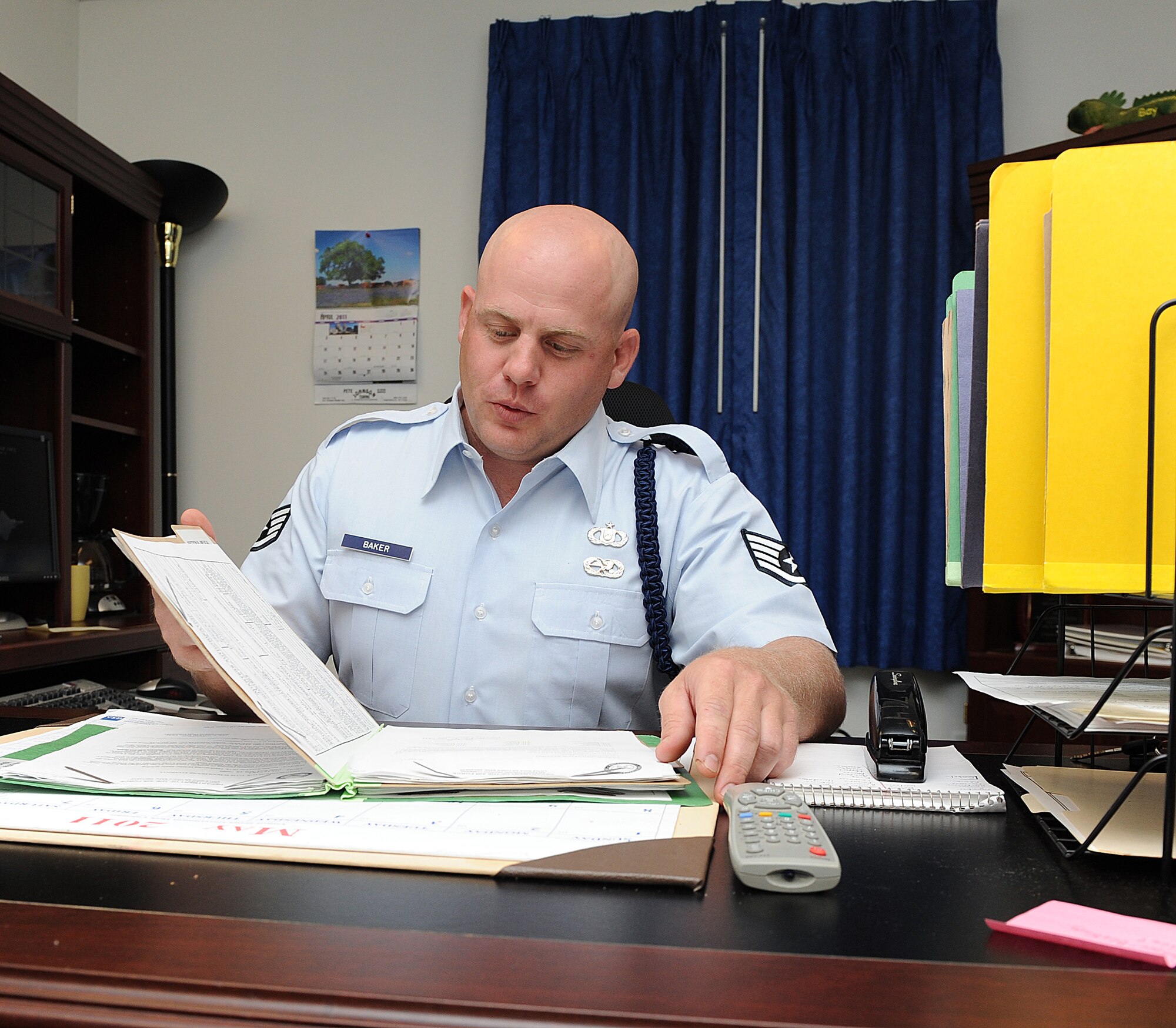 Staff Sgt. Cory Baker, a 714th Training Squadron military training leader, looks through paperwork May 16, 2011, at Little Rock Air Force Base, Ark. MTLs go through every Airman’s paperwork for in-processing and out-processing to make sure they have all required items. (U.S. Air Force photo/Airman 1st Class Ellora Stewart)