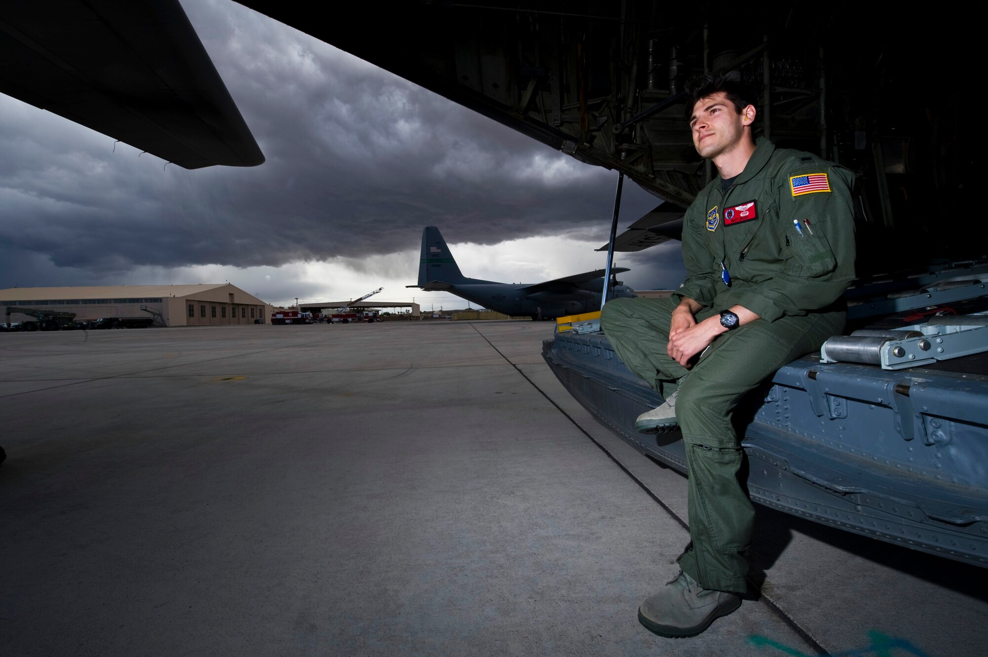 U.S. Air Force 1st Lt. Matt Ables, C-130 Hercules pilot, 50th Airlift Squadron, Little Rock Air Force Base, Ark., relaxes on a C-130 Hercules ramp following a Mobility Air Forces Exercise mission May 18. Approximately 40 C-17 Globemaster III and C-130 aircraft assembled in aerial formations over the Nevada Test and Training Range to conduct air and ground operations as part of the bi-annual, U.S. Air Force Weapons School training event. (U.S. Air Force photo/Senior Airman Brett Clashman)
