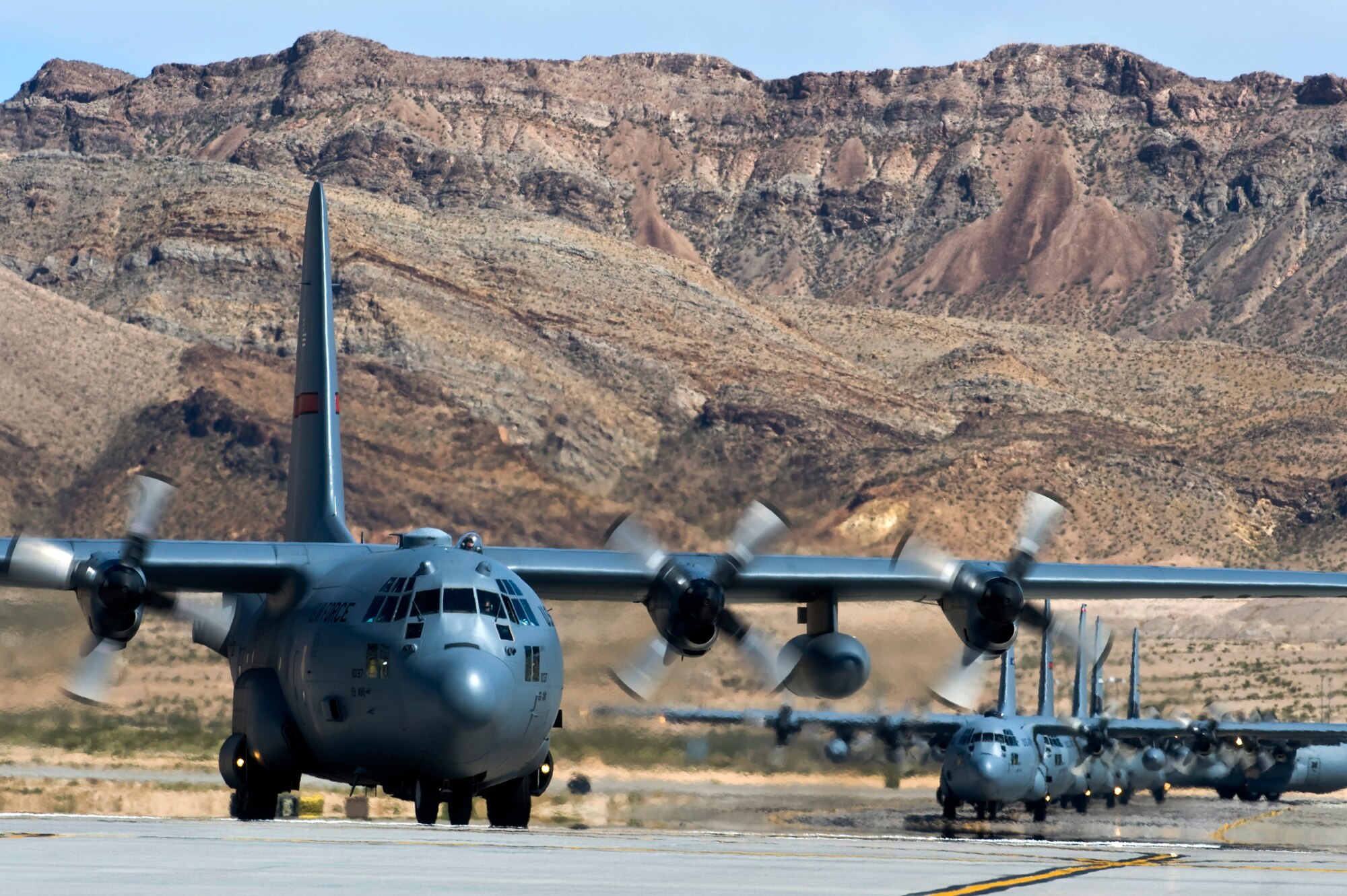 U.S. Air Force C-130 Hercules aircraft taxi at Nellis Air Force Base, Nev. after completing a Mobility Forces Exercise mission May 18. Approximately 40 C-17 Globemaster III and C-130 aircraft assembled in aerial formations over the Nevada Test and Training Range to conduct air and ground operations as part of the bi-annual, U.S. Air Force Weapons School training event. (U.S. Air Force photo/Senior Airman Brett Clashman)
