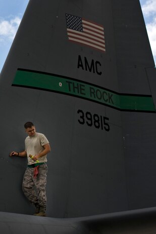 U.S. Air Force Staff Sgt. Christopher Rhodus, a C-130 Hercules crew chief assigned to the19th Aircraft Maintenance Squadron, Little Rock Air Force Base, Ark., performs a post-flight inspection at Nellis Air Force Base, Nev., following a Mobility Forces Exercise mission May 18. Approximately 40 C-17 Globemaster III and C-130 aircraft assembled in aerial formations over the Nevada Test and Training Range to conduct air and ground operations as part of the bi-annual, U.S. Air Force Weapons School training event. (U.S. Air Force photo/Airman 1st Class Matthew Lancaster)