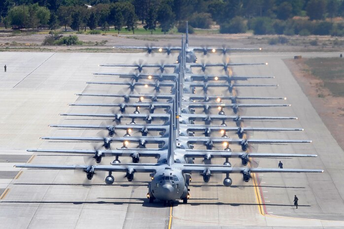 U.S. Air Force C-130 Hercules aircraft taxi at Nellis Air Force Base, Nev. after completing a Mobility Air Forces Exercise mission May 18.  Approximately 40 C-17 Globemaster III and C-130 aircraft assembled in aerial formations over the Nevada Test and Training Range to conduct air and ground operations as part of the bi-annual, U.S. Air Force Weapons School training event. (U.S. Air Force Photo/Staff Sgt. Taylor Worley)