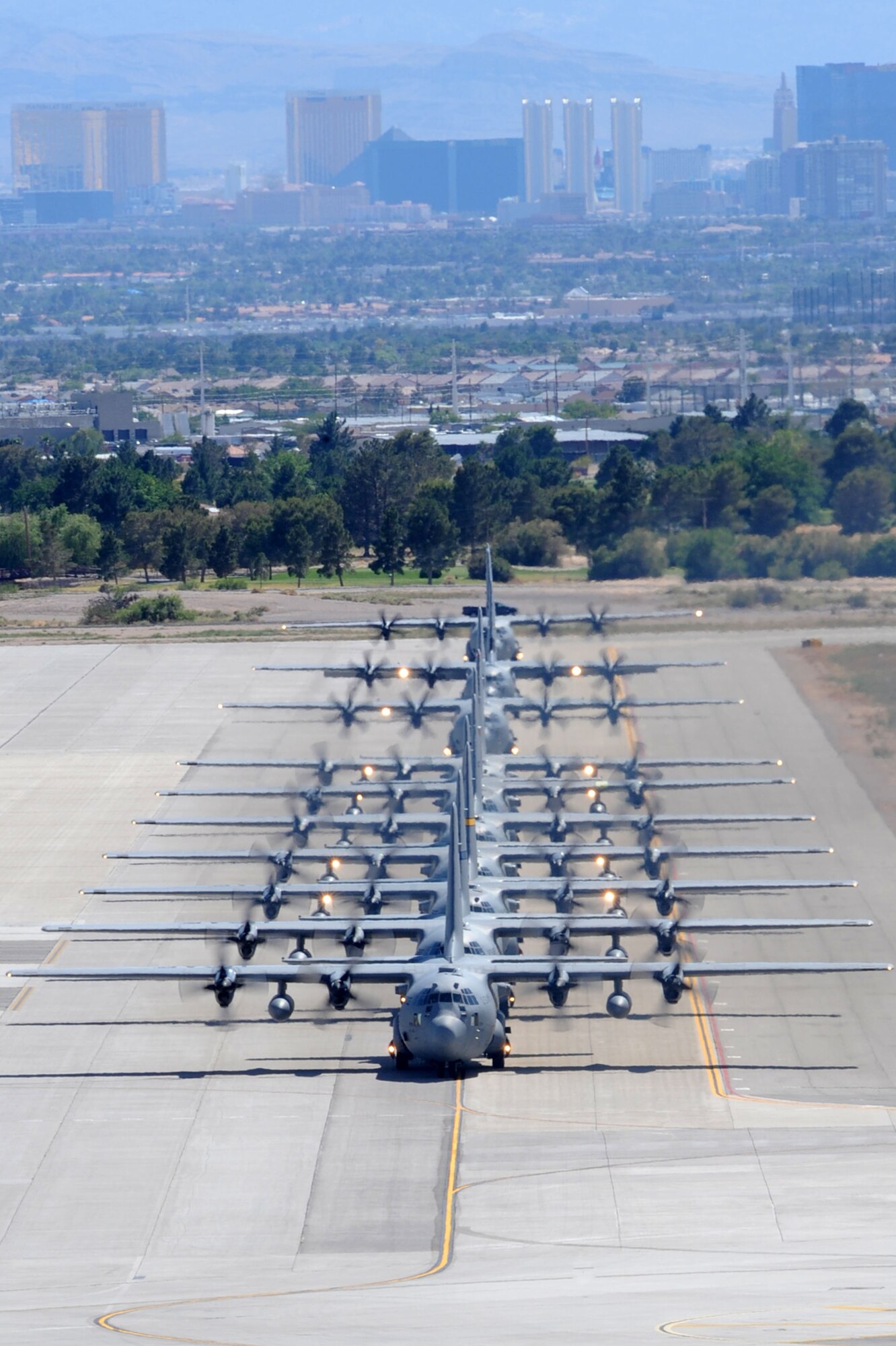 U.S. Air Force C-130 Hercules aircraft taxi at Nellis Air Force Base, Nev. after completing a Mobility Air Forces Exercise mission May 18.  Approximately 40 C-17 Globemaster III and C-130 aircraft assembled in aerial formations over the Nevada Test and Training Range to conduct air and ground operations as part of the bi-annual, U.S. Air Force Weapons School training event. (U.S. Air Force Photo/Staff Sgt. Taylor Worley)

