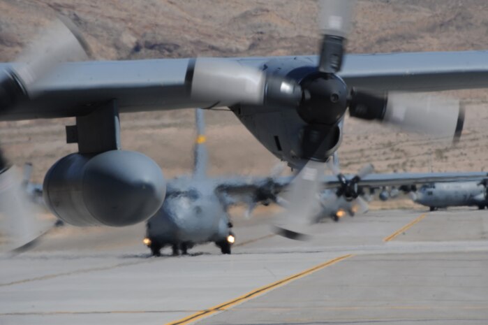 A formation of  U.S. Air Force C-130 Hercules aircraft taxi  at Nellis Air Force Base, Nev. May 18 following a Mobility Air Forces Exercise. More than 40 C-17 Globemaster III and C-130 Hercules cargo aircraft assembled in aerial formations over the Nevada Test and Training Range to conduct air and ground operations as part of the bi-annual U.S. Air Force Weapons School training exercise.
(U.S. Air Force photo/ Master Sgt. Kevin J. Gruenwald)







