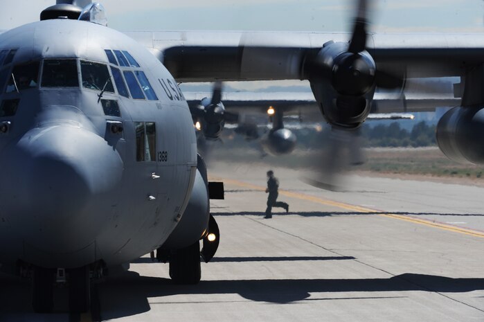 An aircrew member conducts a post flight inspection of a U.S. Air Force C-130 Hercules aircraft at Nellis Air Force Base, Nev. following a Mobility Air Forces Exercise mission May 18. More than 40 C-17 Globemaster III and C-130 aircraft assembled in aerial formations over the Nevada Test and Training Range to conduct air and ground operations as part of the bi-annual U.S. Air Force Weapons School training event. (U.S. Air Force photo/Master Sgt. Kevin J. Gruenwald)