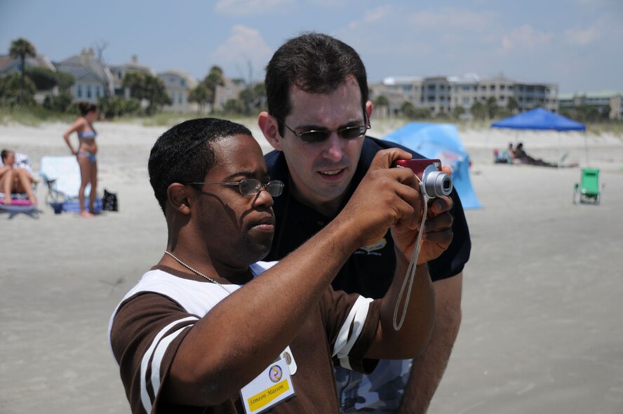 Hilton Head Island, S.C. -- School isn't the only place Simeon Masson learns about the world around him.  This weekend, Masson paired up with Michael Dukes, a public affairs specialist at Charleston Air Force Base, to learn photography skills.  Masson and more than 30 other family members took to the beach and photographed their environment.  The families were there as part of the Yellow Ribbon Program, a workshop sponsored by the Air Force Reserve Command to help families deal with having a loved one deploy. (Official U.S. Air Force photo by Staff Sgt. Shawn Rhodes)