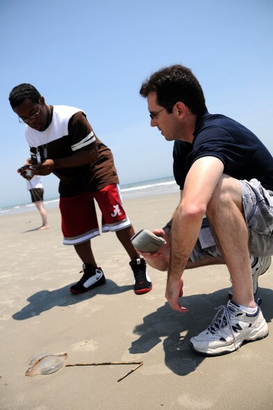 Hilton Head Island, S.C. -- School isn't the only place Simeon Masson learns about the world around him.  This weekend, Masson paired up with Michael Dukes, a public affairs specialist at Charleston Air Force Base, to learn photography skills.  Masson and more than 30 other family members took to the beach and photographed their environment.  The families were there as part of the Yellow Ribbon Program, a workshop sponsored by the Air Force Reserve Command to help families deal with having a loved one deploy. (Official U.S. Air Force photo by Staff Sgt. Shawn Rhodes)