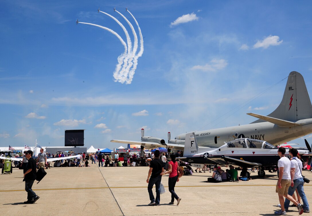 The Geico Skytypers preform an aerial demonstration high above the skies of the 2011 Joint Service Open House May 21 at Joint Base Andrew, Md. JSOH affords the public an opportunity to meet the men and women of the Armed Forces and to see military equipment from the Navy, Marines, Army, Air Force and Coast Guard. JSOH is planned and conduct through the efforts of active duty, guard and reserve servicemembers, as well as civilian employees, retirees and family members. (U.S. Air Force photo by Staff Sgt. Nichelle Anderson)
