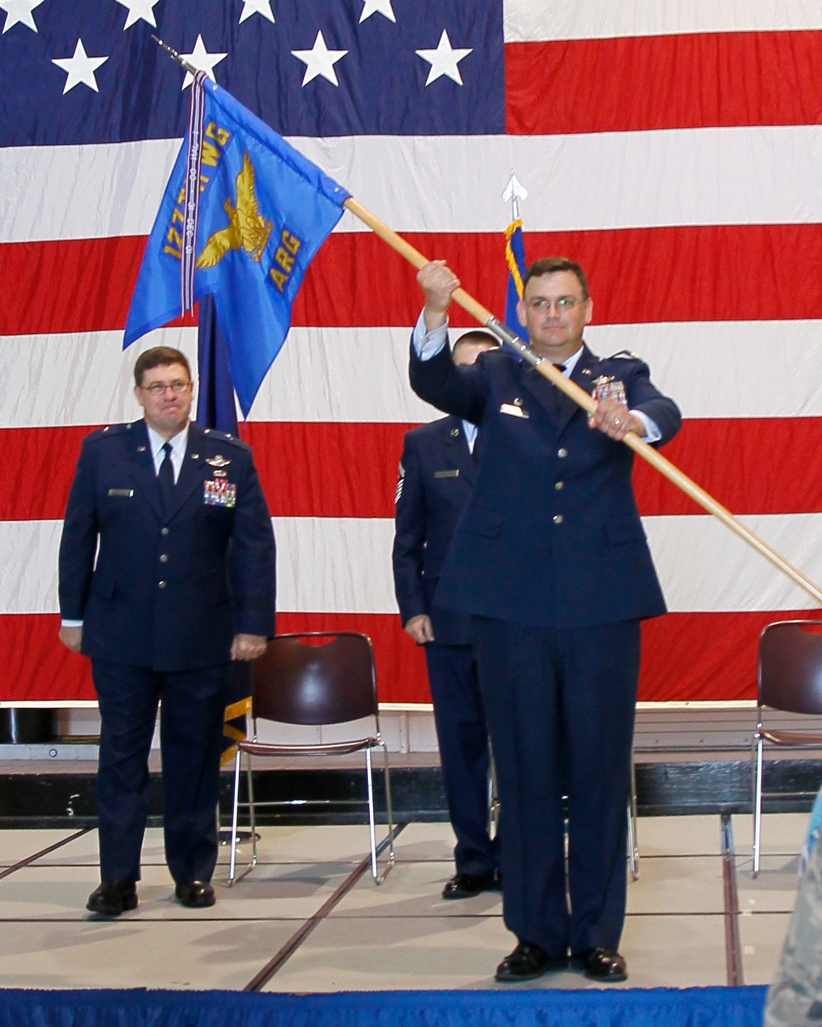 Lt. Col. David Brooks holds the flag representing the 127th Air Refueling Group as he assumes command of that group during a May 21, 2011, ceremony at Selfridge Air National Guard Base, Mich. Behind Brooks are Brig. Gen. Michael Peplinski, 127th Wing commander, and Senior Master Sgt. Michael Douglas. Brooks, a KC-135 Stratotanker pilot, had been serving as the commander of the 171st Air Refueling Squadron, a component of the 127th ARG. (USAF photo by MSgt. Terry Atwell)  (Released)