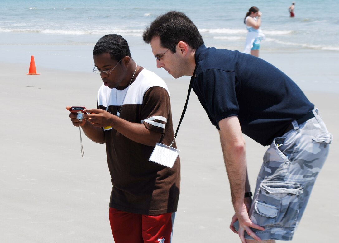 MIchael Dukes teaches a child photography skills during a class at Air Force Reserve Command’s Yellow Ribbon Reintegration event held at Hilton Head Island, S.C. on May 20-22, 2011.  (U.S. photo/Capt. Wayne Capps)
