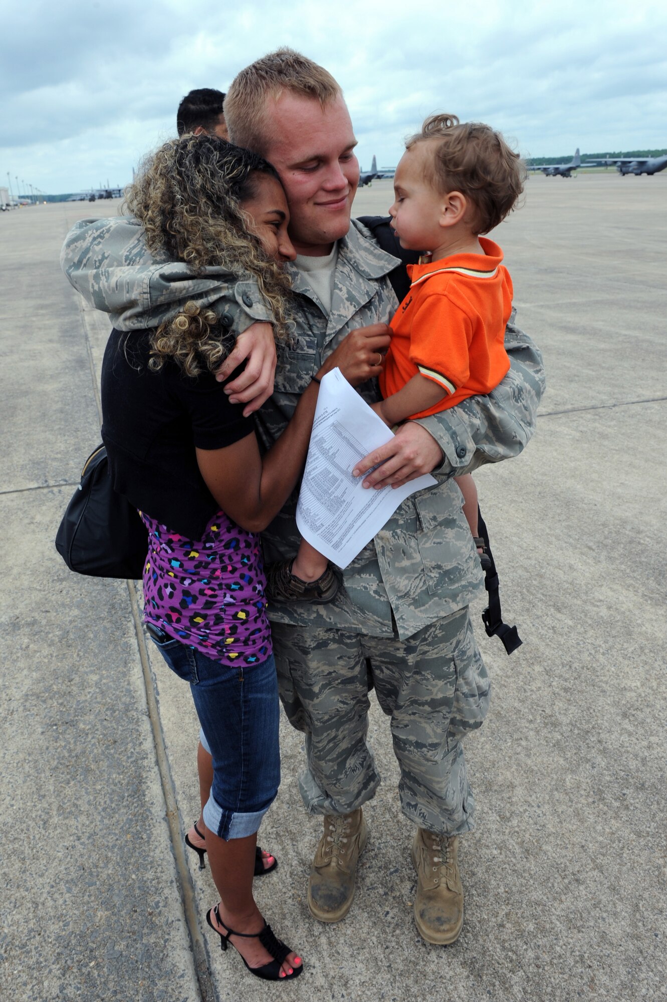 Senior Airman Brandon Rousseau is greeted by his family on the base flightline May 21, 2011, at Little Rock Air Force Base, Ark. Airman Rousseau was one of the nearly 200 Team Little Rock Airmen supporting operations in Southwest Asia. (U.S. Air Force Photo by Airman 1st Class Rusty Frank)