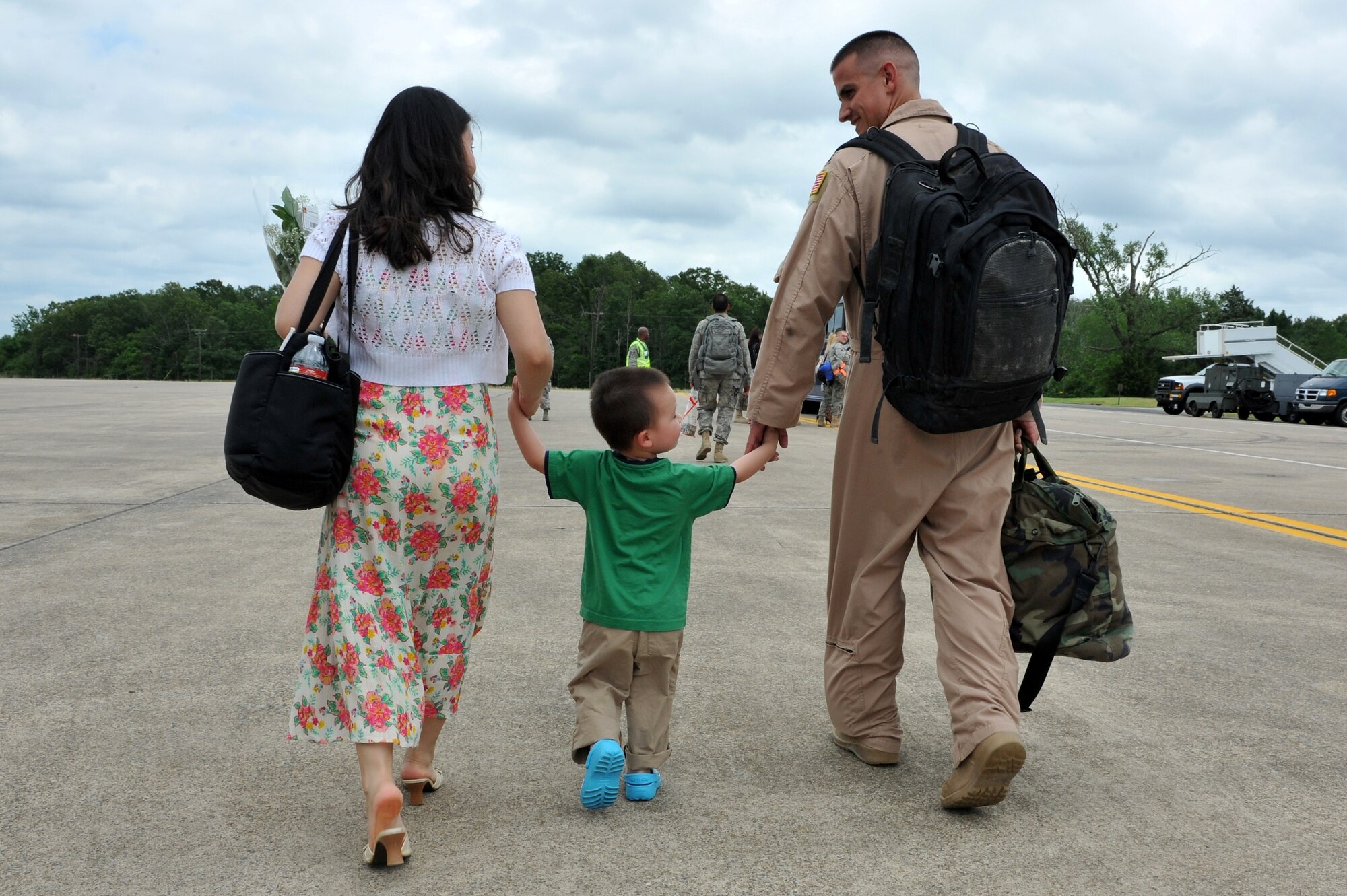 Capt. Anthony Wright, 61st Airlift Squadron navigator, leaves from the flightline with his wife SuJin, who is 7 months pregnant, and son, Matthew, May 21, 2011 on the Little Rock Air Force Base, Ark. Nearly 200 Team Little Rock Airmen reunited with family members and friends Saturday after returning from months of deployments supporting operations in Southwest Asia. (U.S. Air Force photo/Staff Sgt. Chris Willis)