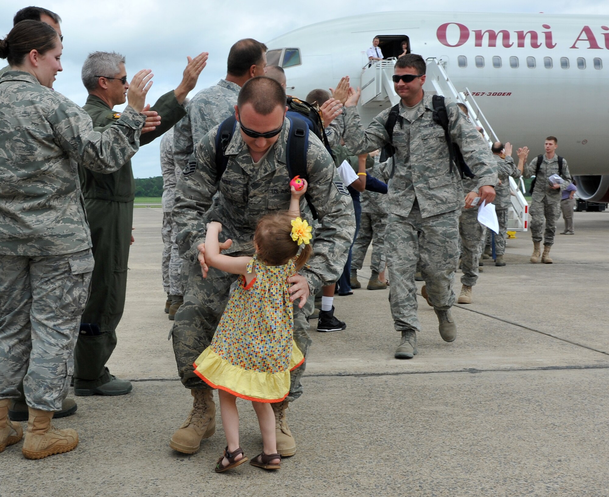 Staff Sgt. Louis Bell, 19th Aircraft Maintenance Squadron crew chief, is greeted by daughter, Anjulie, on the base flightline May 21, 2011, at Little Rock Air Force Base, Ark. Nearly 200 Team Little Rock Airmen reunited with family members and friends Saturday after returning from months of deployments supporting operations in Southwest Asia. (U.S. Air Force photo/Staff Sgt. Chris Willis)