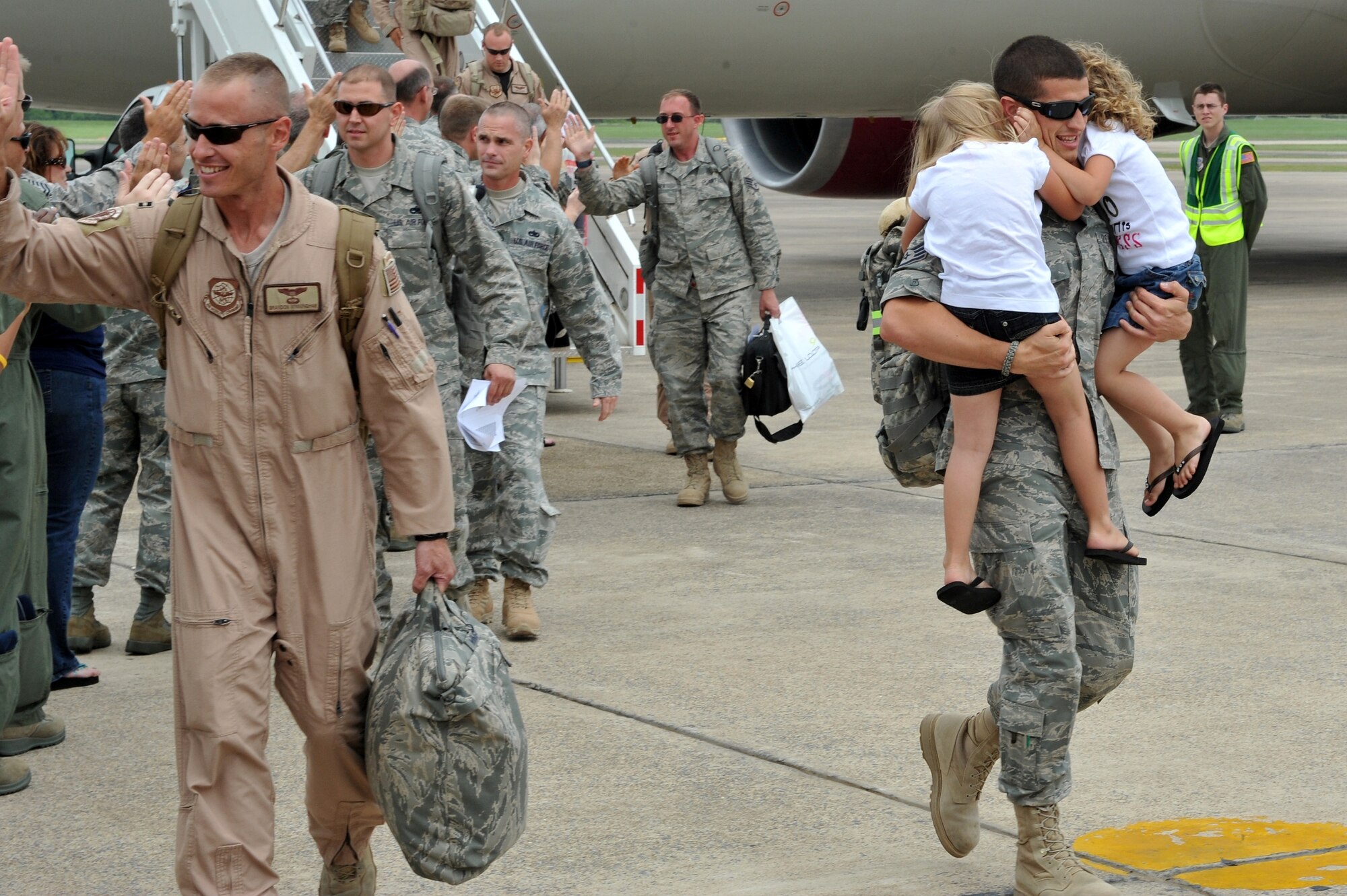 Staff Sgt. Rocky Hopper, 19th Component Maintenance Squadron fuel system journeyman, is greeted by his daughters Tiara, Tavia, on the base flightline, May 21, 2011, at Little Rock Air Force Base, Ark. Nearly 200 Team Little Rock Airmen reunited with family members and friends Saturday after returning from months of deployments supporting operations in Southwest Asia. (U.S. Air Force photo/Staff Sgt. Chris Willis)