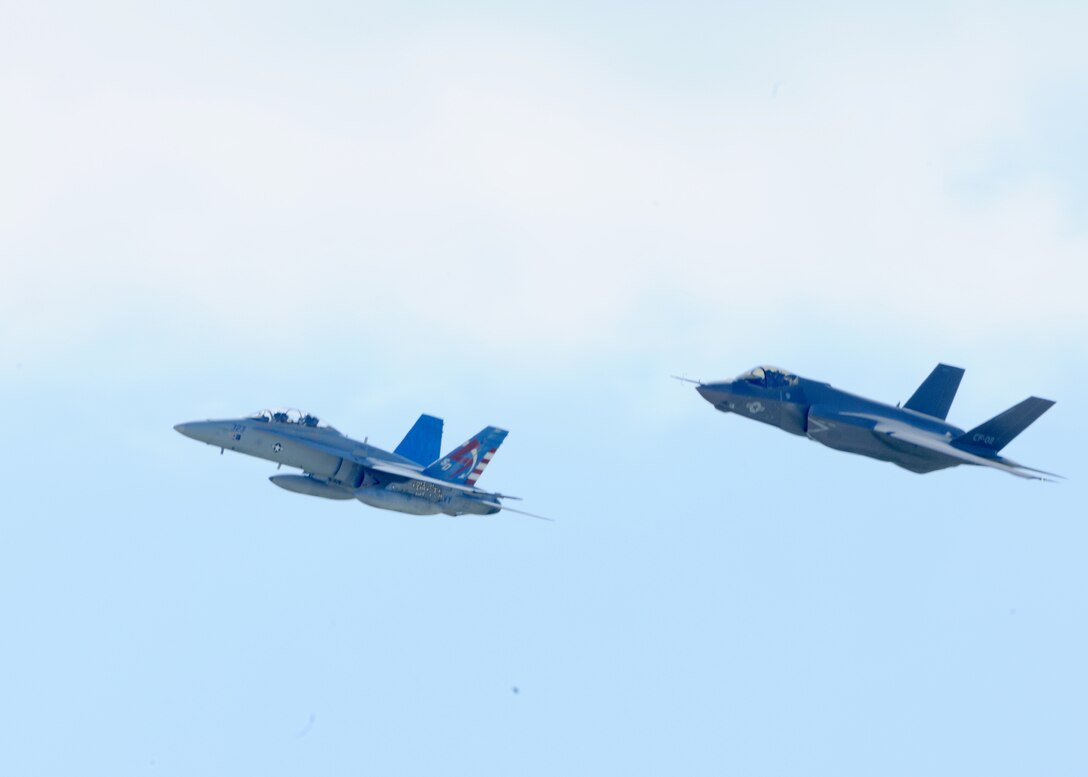 An F-35C Joint Strike Fighter and a F/A-18 Hornet pass over the 2011 Joint service Open House during the opening ceremonies May 21.The JSOH affords the public an opportunity to meet the men and women of the Armed Forces and to see military equipment from the Navy, Marines, Army, Air Force, and Coast Guard. JSOH is planned and conducted through the efforts of active duty, guard and reserve servicemembers, as well as civilian employees, retiress and family members. (U.S. Air Force photo by Senior Airman Matt Coleman-Foster)