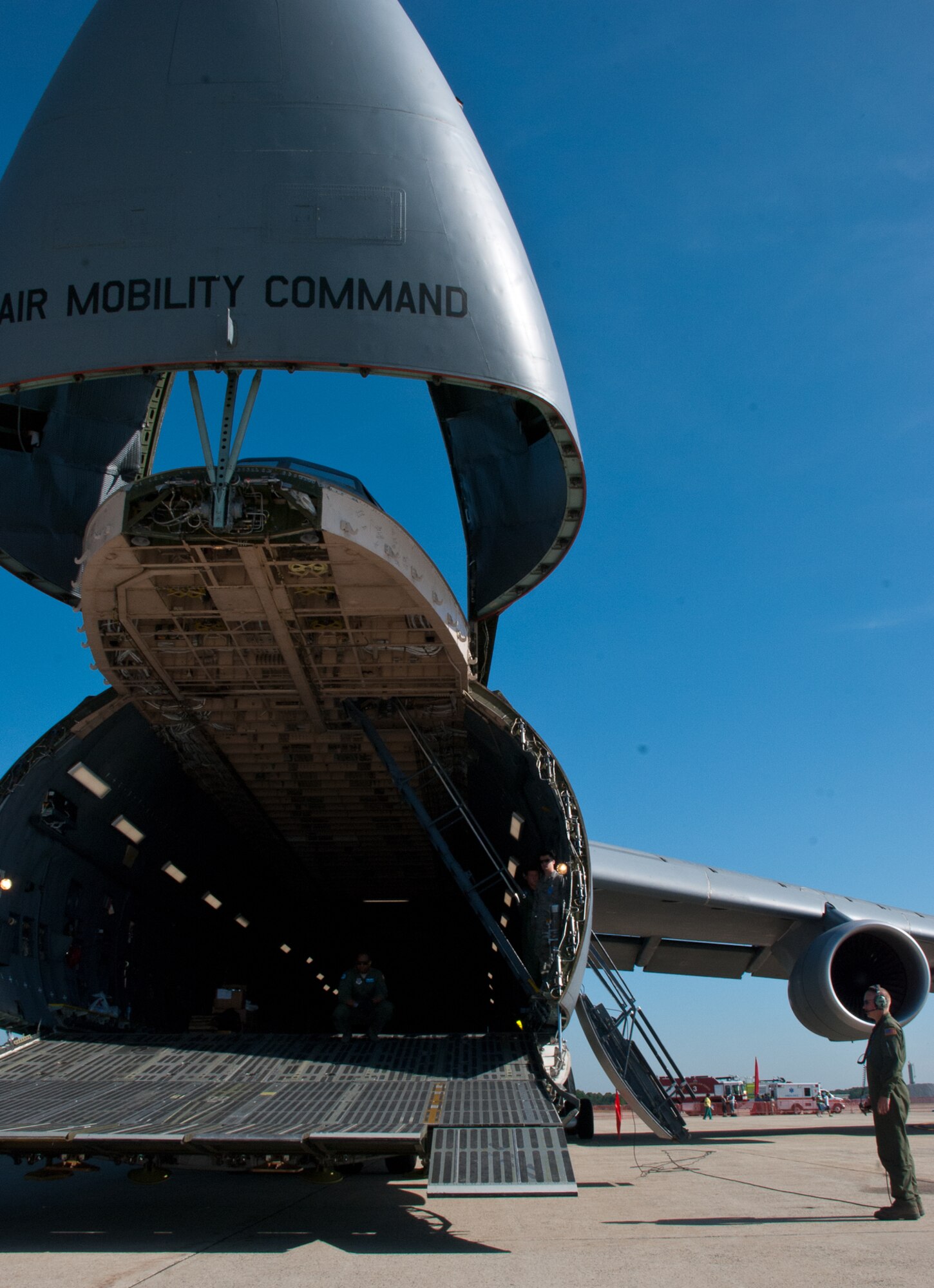 JOINT BASE ANDREWS, Md. -- Staff Sgt. Garrett Reed, 9th Airlift Squadron, Dover Air Force Base, Del., performs scanner duty by observing the right and left landing gear of a C-5  Super Galaxy during the Joint Service Open House here May 21, 2011. The JSOH affords the public an opportunity to meet the men and women of the Armed Forces and to see military equipment from the Navy, Marines, Army, Air Force and Coast Guard. JSOH is planned and conducted through the efforts of active duty, guard and reserve service members, as well as civilian employees, retirees and family members. (U.S. photo /Staff Sgt. Sophia Piellusch)