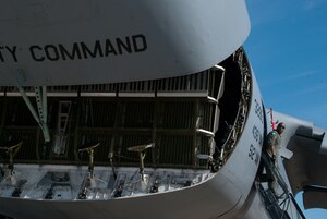JOINT BASE ANDREWS, Md. -- Staff Sgt. Mike Faison, 9th Airlift Squadron, Dover Air Force Base, Del. loadmaster, coordinates with a cockpit flight operator who is opening the nose of a C-5 Galaxy during the Joint Service Open House here May 21, 2011. The JSOH affords the public an opportunity to meet the men and women of the Armed Forces and to see military equipment from the Navy, Marines, Army, Air Force and Coast Guard. JSOH is planned and conducted through the efforts of active duty, guard and reserve service members, as well as civilian employees, retirees and family members. (U.S. photo /Staff Sgt. Sophia Piellusch)