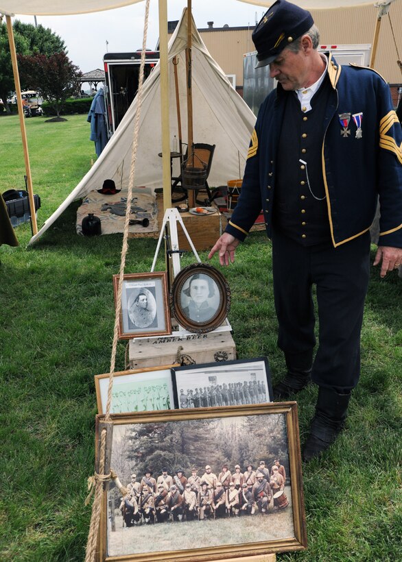 Mr. Eddie Roberts, Sons of Union Veterans of the Civil War commander and Civil War soldier reenactor, displays family photographs and other Civil War artifacts at the 2011 Joint Service Open House at Joint Base Andrews, Md., May 20. The JSOH 2011 affords the public an opportunity to meet the men and women of the Armed Forces and to see military equipment through the efforts of active duty, guard and reserve servicemembers, as well as civilians employees, retirees and family members. (U.S. Air Force photo by Airman 1st Class Lindsey A. Beadle)