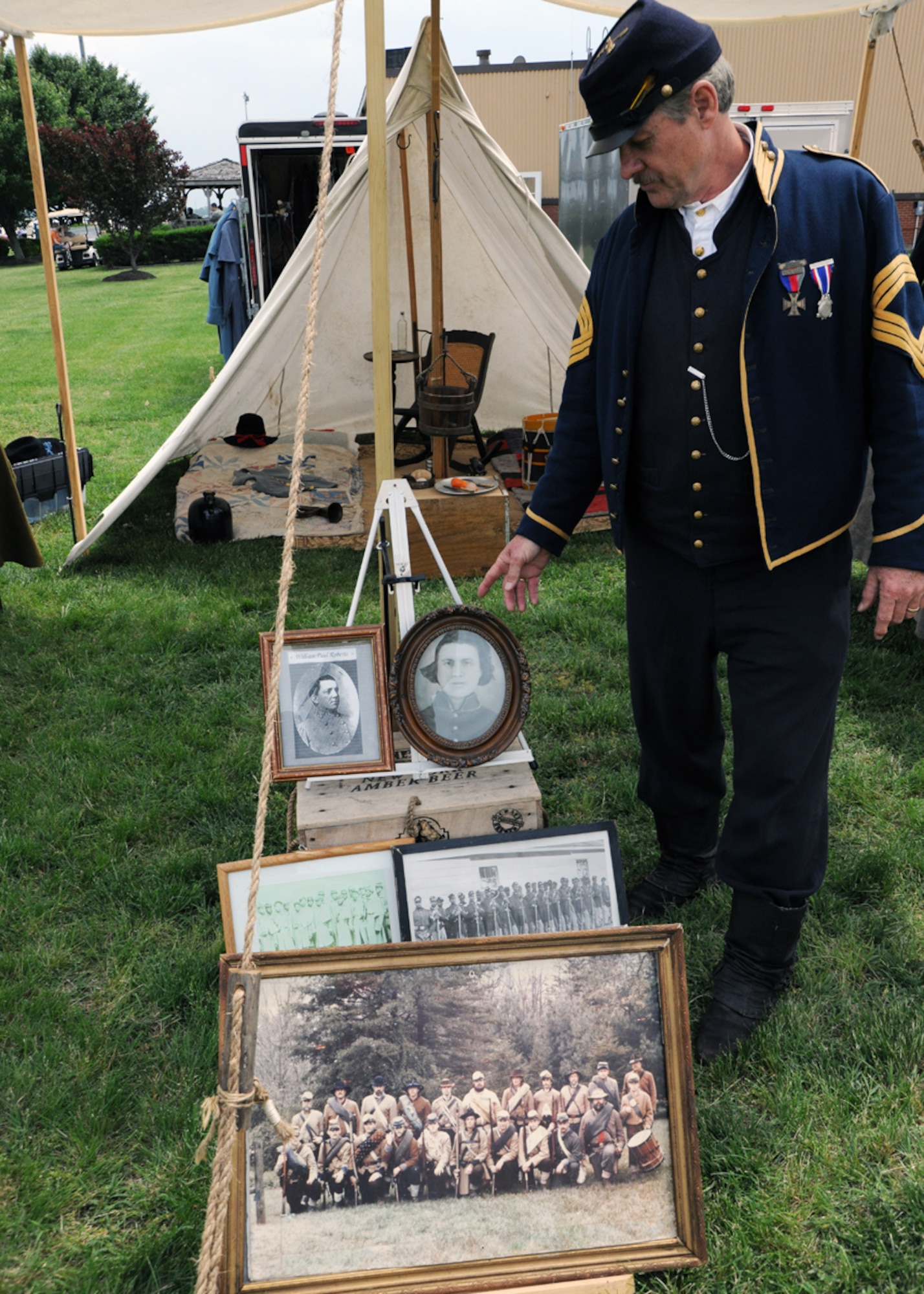Mr. Eddie Roberts, Sons of Union Veterans of the Civil War commander and Civil War soldier reenactor, displays family photographs and other Civil War artifacts at the 2011 Joint Service Open House at Joint Base Andrews, Md., May 20. The JSOH 2011 affords the public an opportunity to meet the men and women of the Armed Forces and to see military equipment through the efforts of active duty, guard and reserve servicemembers, as well as civilians employees, retirees and family members. (U.S. Air Force photo by Airman 1st Class Lindsey A. Beadle)