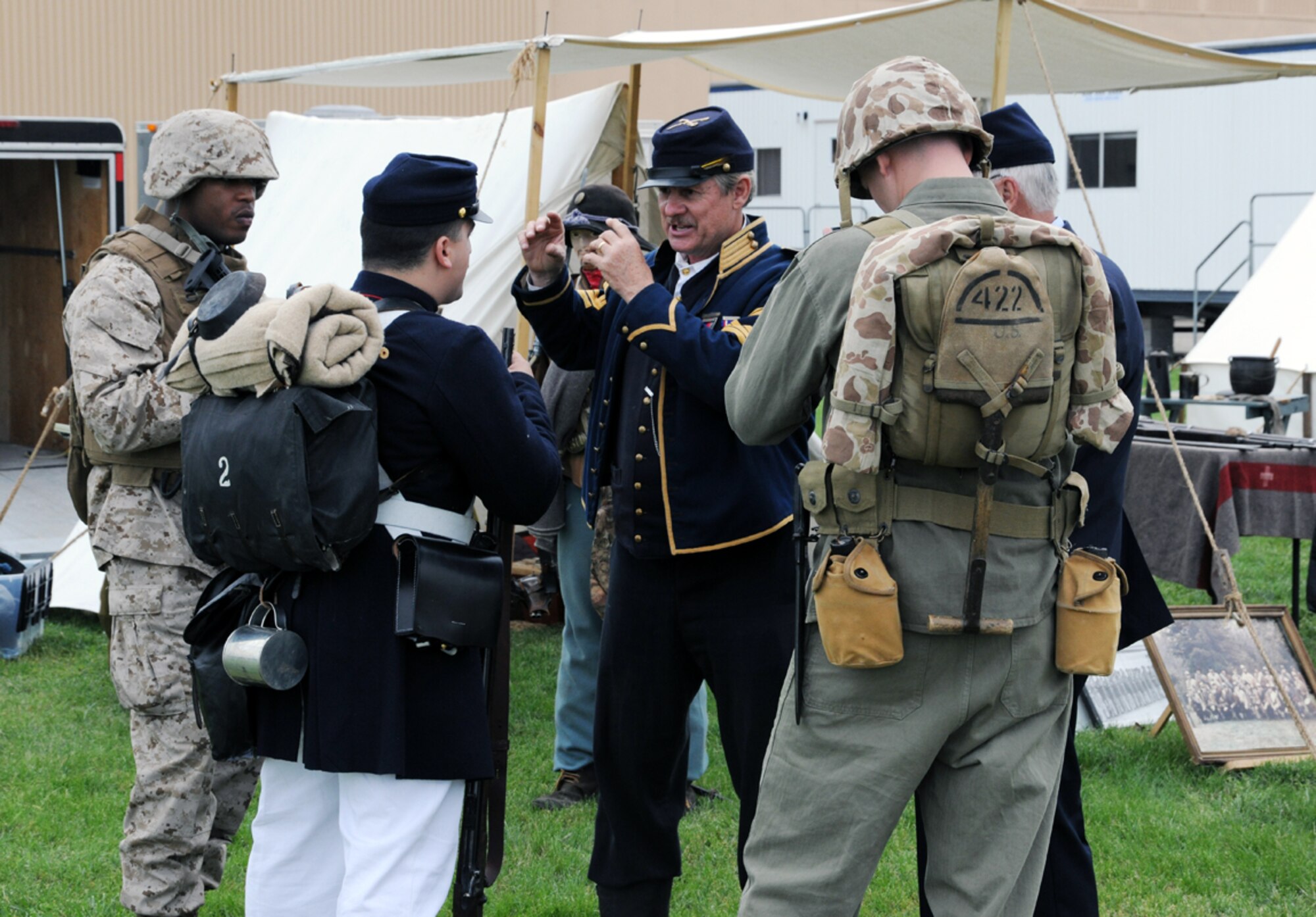 Mr. Eddie Roberts, Sons of Union Veterans of the Civil War commander and Civil War soldier reenactor, talks with current American military members at a SUVCW tent display at the 2011 Joint Service Open House at Joint Base Andrews, Md., May 20. The JSOH 2011 affords the public an opportunity to meet the men and women of the Armed Forces and to see military equipment through the efforts of active duty, guard and reserve servicemembers, as well as civilians employees, retirees and family members. (U.S. Air Force photo by Airman 1st Class Lindsey A. Beadle)