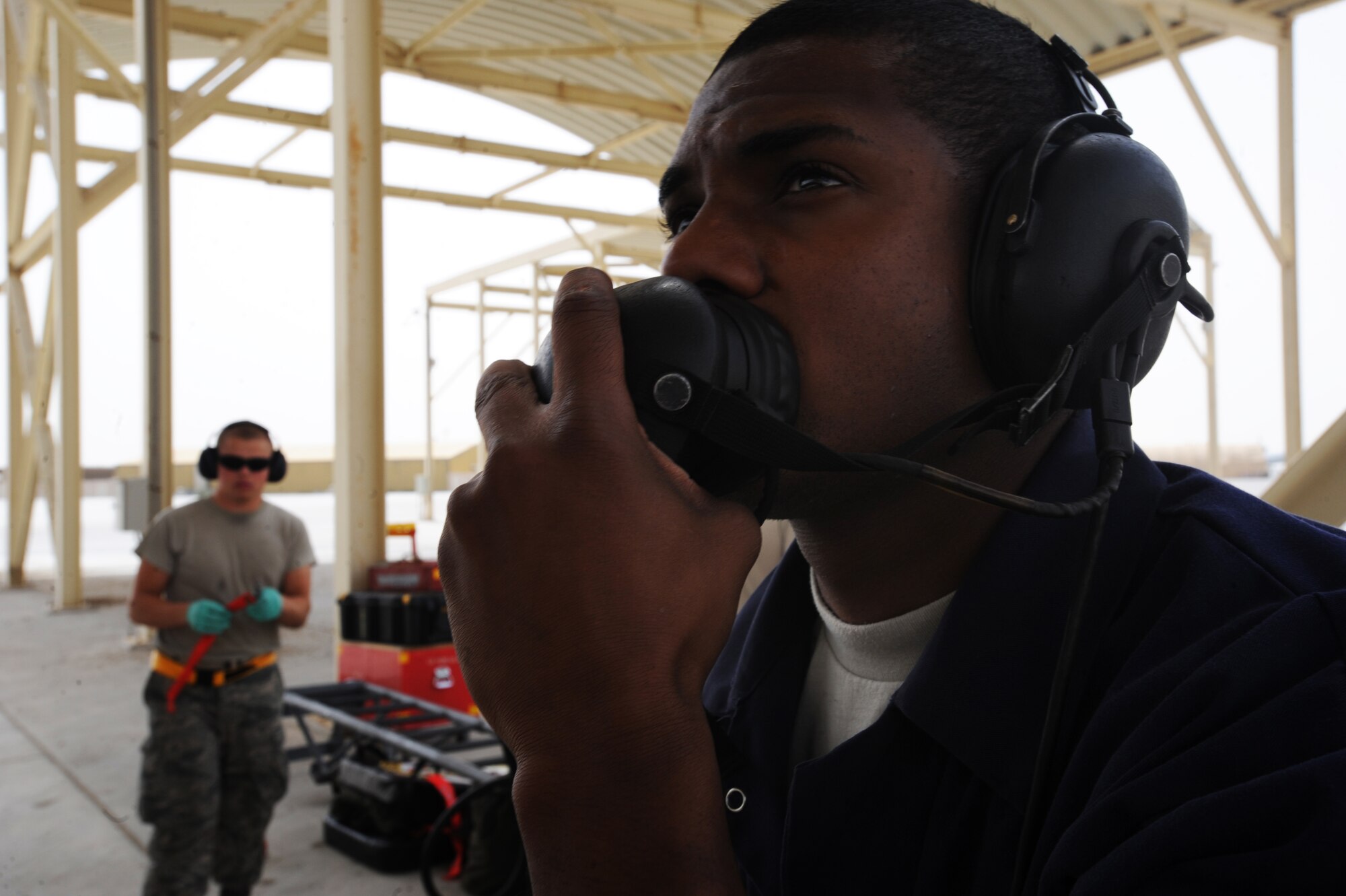 Airman Brian Carter, 380th Expeditionary Aircraft Maintenance Squadron, communicates with the pilot as he tests the controls of the wings on the F-15C Eagle aircraft May 3, 2011. The F-15 Eagle is an all-weather, extremely maneuverable, tactical fighter designed to permit the Air Force to gain and maintain air supremacy over the battlefield. Airman Carter is deployed from Lakenheath AB, U.K. (U.S. Air Force photo by Senior Airman Maynelinne De La Cruz)  