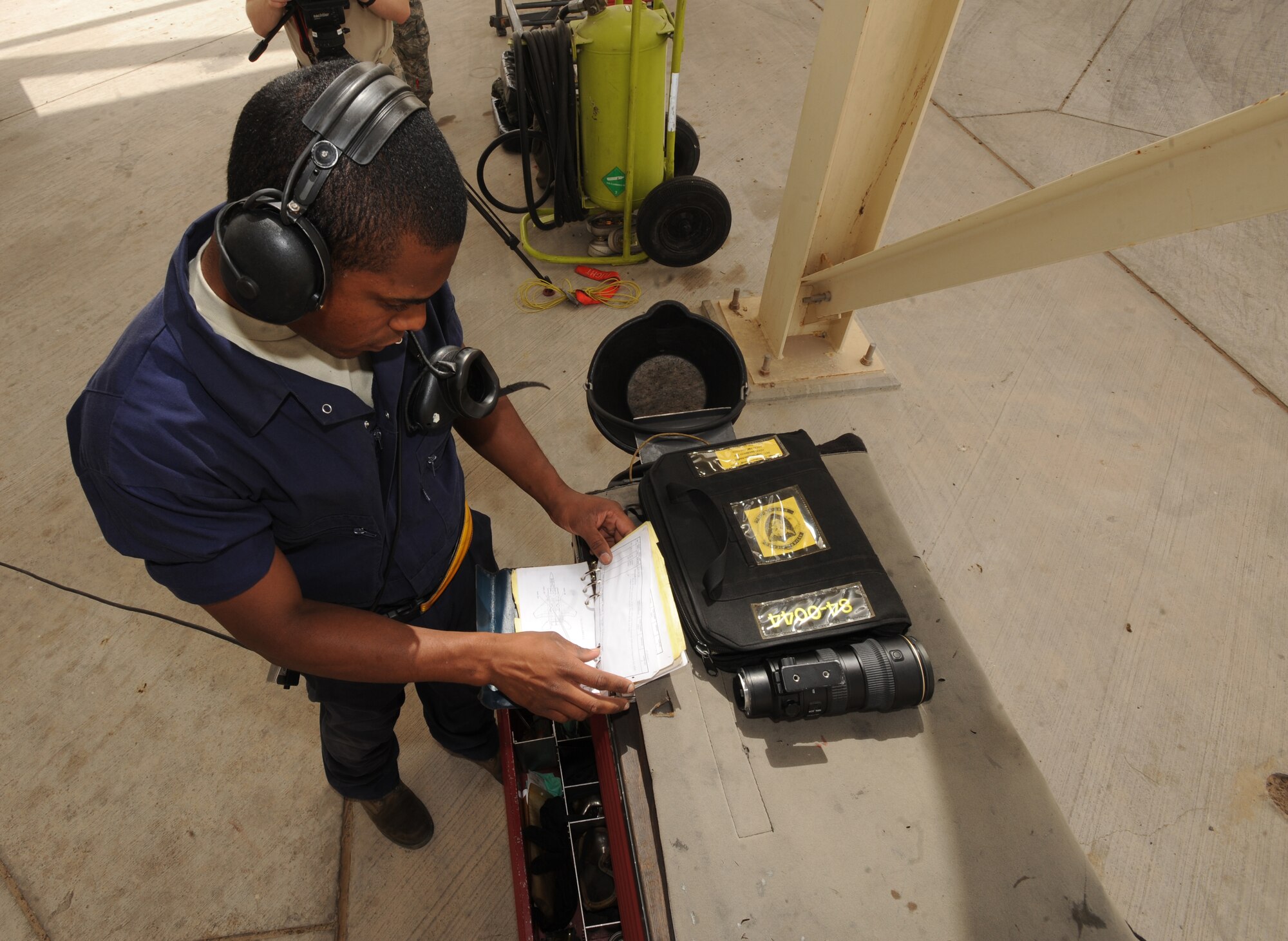 Airman Brian Carter, 380th Expeditionary Aircraft maintenance Squadron crew chief, reviews a check list before launching his F-15C Eagle aircraft May 3, 2011, in Southwest Asia. With no room for mishaps, going through the checklist warrants a safe flight. Airman Carter is deployed from Lakenheath AB, U.K. (U.S. Air Force photo by Senior Airman Maynelinne De La Cruz)