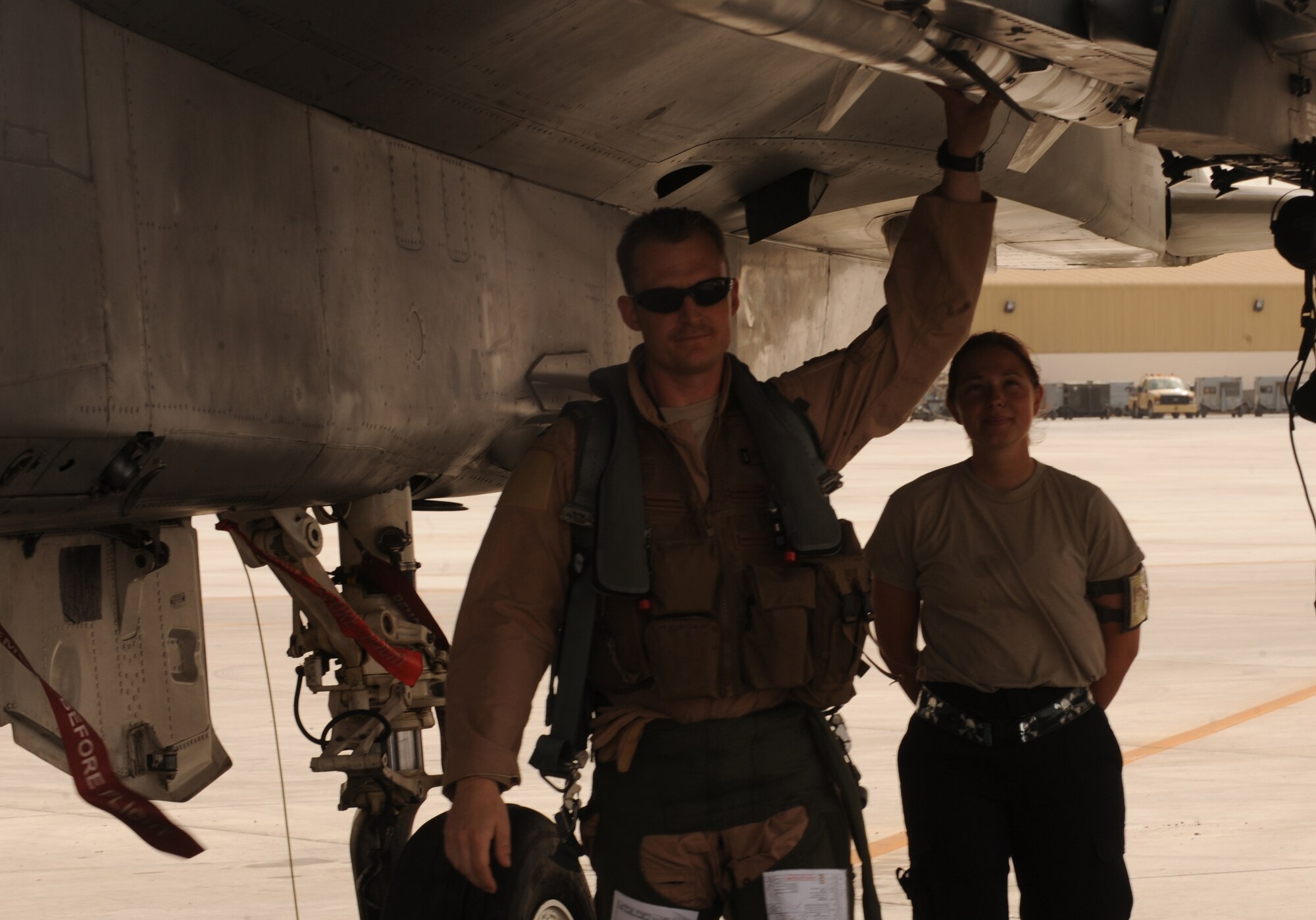 Airman 1st Class Caitlin MacKenzie, 380th Expeditionary Aircraft Maintenance Squadron, meets with the F-15C Eagle pilot before take-off May 3, 2011, in Southwest Asia. Before getting into the cockpit, the pilot completes a 360 inspection with Airman Carter, the Eagle's crew chief. Airman Carter is deployed from Lakenheath AB, U.K. (U.S. Air Force photo by Senior Airman Maynelinne De La Cruz)   