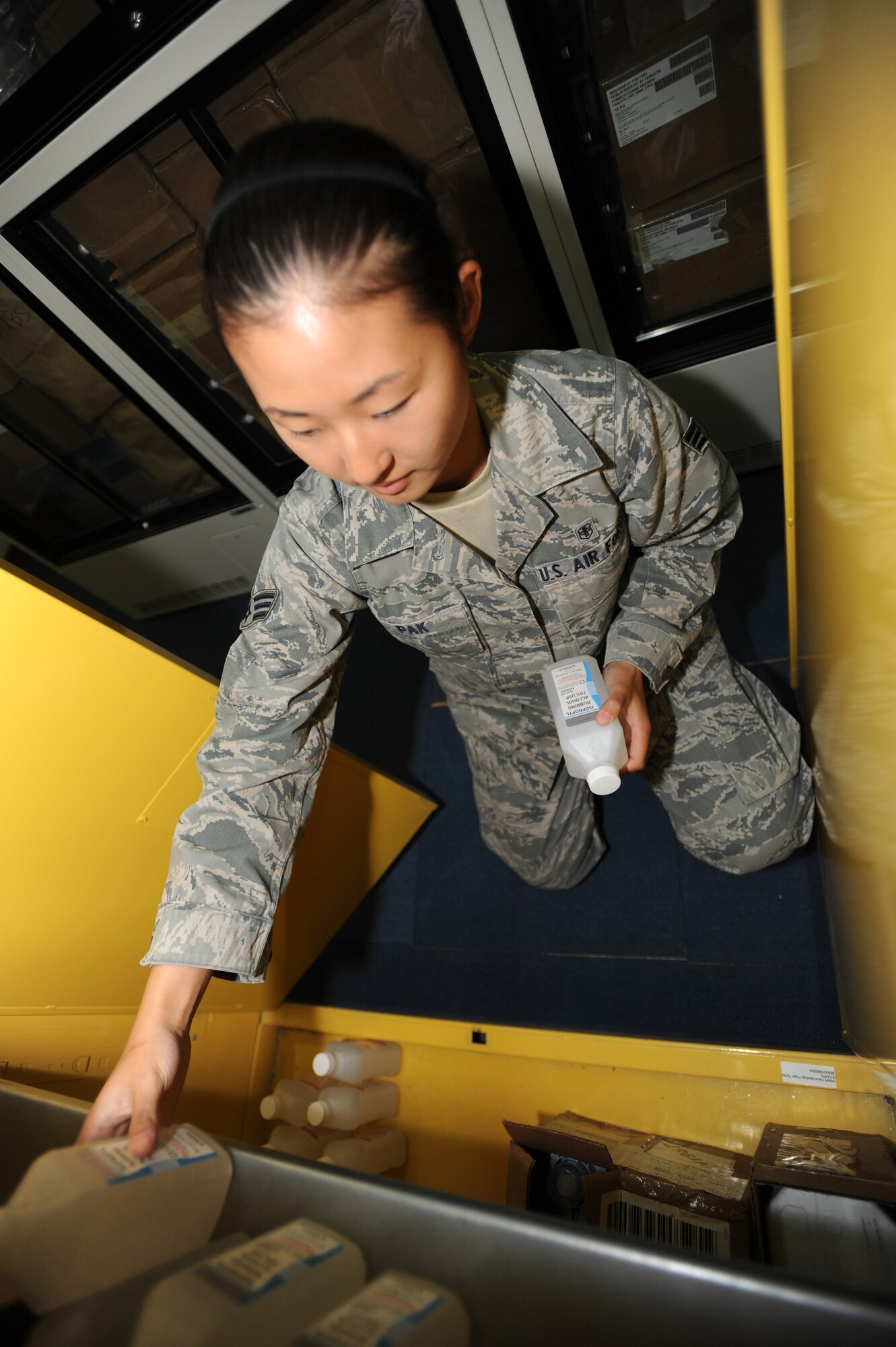 Senior Airman Lily Pak 380th Expeditionary Medical Group makes sure that all flammable products are separated from others and kept in an easily identifiable container, April 28, 2011. Some of these products include ethyl alcohol, hand sanitizer, and histofreezer kits. (U.S Air Force photo by Senior Airman Maynelinne De La Cruz)