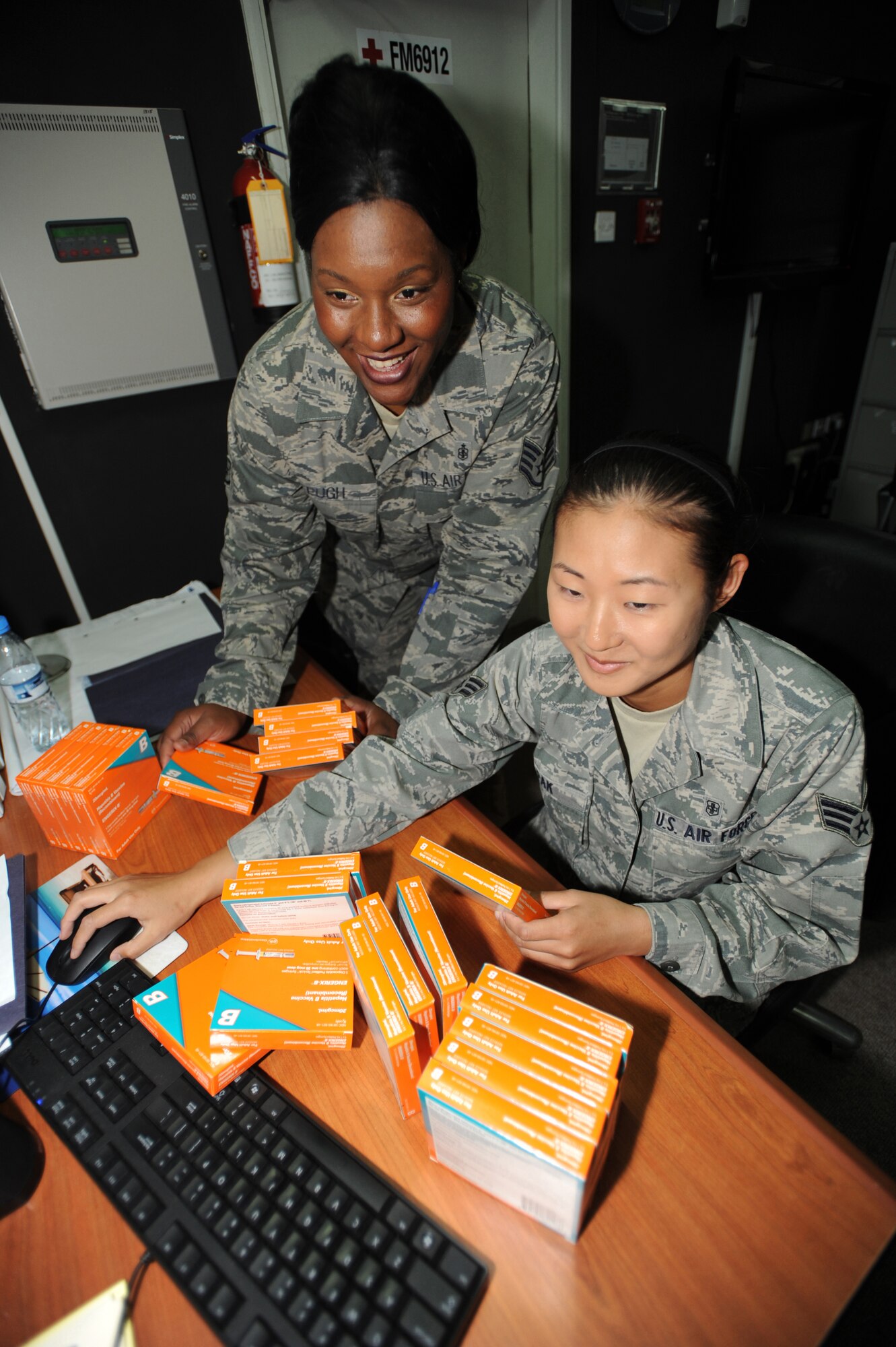 Staff Sgt. Laveena Pugh (left), 380th Expeditionary Medical Group, and Senior Airman Lily Pak 380 EMDG, uses the Defense Medical Logistics Standard Support system to order and check off received items April 28, 2011.  Some of the items that they process are Hepatitis B, Yellow Fever, and Anthrax Vaccines. (U.S. Air Force photo by Senior Airman Maynelinne De La Cruz)
