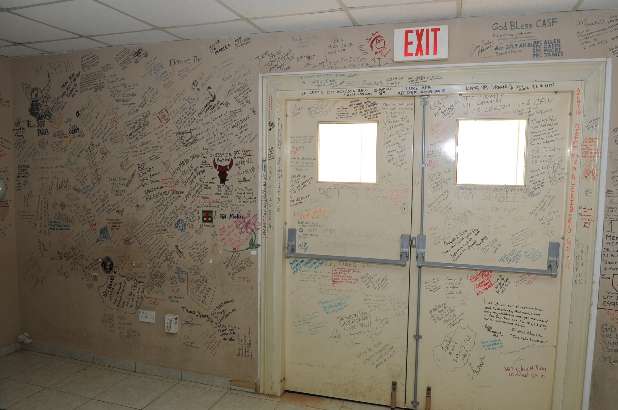 JOINT BASE BALAD, Iraq--Service members left their marks on the walls of the contingency airlift staging facility.  Since the troop surge in 2007, wounded warriors and top military officials have been writing messages as a way to commemorate their fallen comrades. Words of thanks were also left for the JBB hospital staff. (U.S. Air Force photo/Staff Sgt. Keyonna Fennell)