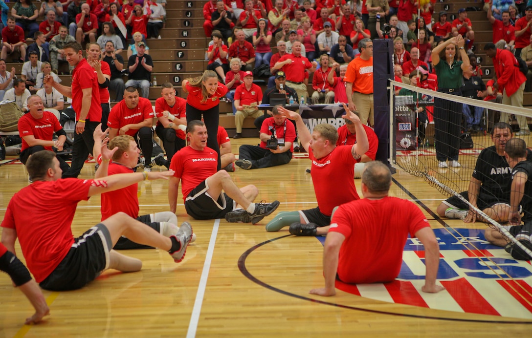 Lance Cpl. Jese Schag, a Sheridan, Ill., native on the All-Marine sitting volleyball team, leads the Marines in a celebration after a point during the gold medal game against the Army May 20, 2011, at the Olympic Training Center in Colorado Spring, Colo. It took the Marines just the first two matches of a best-of-three game series to beat the Army and defend their title in the Warrior Games event. The All-Marine sitting volleyball team, consisting of active-duty and veteran wounded warriors, went head-to-head against all other branches of the Armed Forces, including a Special Operations Command team. The Marines were undefeated.