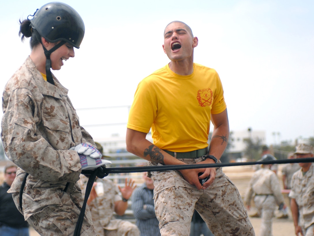 Angela Nishnic finishes the rappel tower while her husband Sgt. Robert Nishnic a 2nd Battalion drill instructor, yells at her like a recruit. The Depot Battalions gave their wives a chance to walk in recruits shoes and see how demanding their husbands days are.