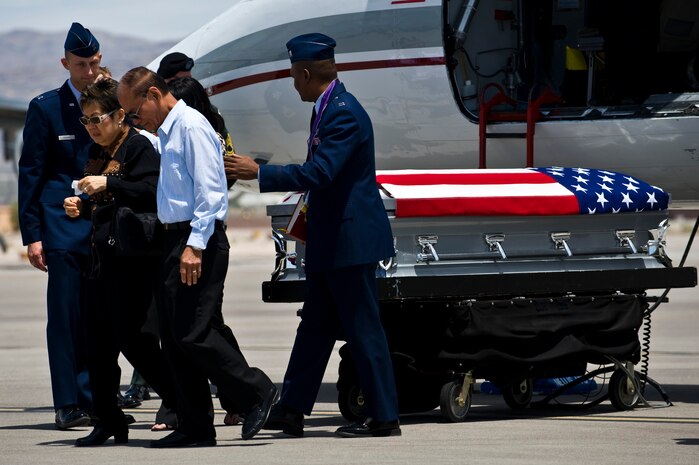 NELLIS AIR FORCE BASE, Nev.-- Norma and Renato Hermogino, parents of U.S. Army Sgt. Ken Hermogino, are consoled by Air Force chaplains during a dignified transfer ceremony for their son at Nellis Air Force Base, May 21, 2011. Sergeant Hermogino died May 9 in Herat province, Afghanistan, of injuries sustained in a non-combat related vehicle accident. Sergeant Hermogino graduated from Basic High School in Las Vegas in 1998 and, prior to transitioning to the U.S. Army in 2009, he served eight years in the U.S. Air Force as a medical administrator. He will be laid to rest with full military honors at the Southern Nevada Veterans Memorial Cemetery in Boulder City. (U.S. Air Force photo/Senior Airman Brett Clashman)