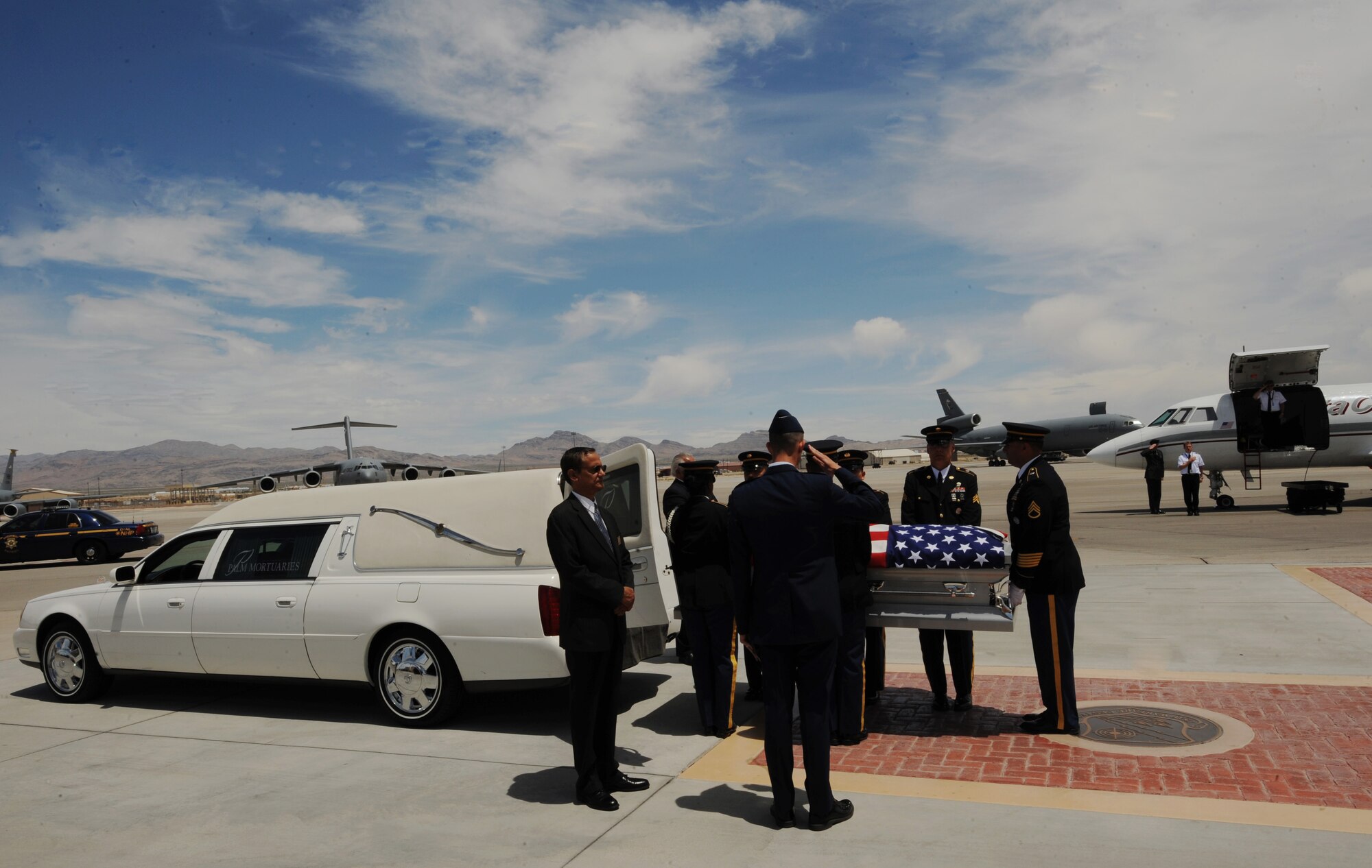 NELLIS AIR FORCE BASE, Nev.-- A U.S. Army pallbearer team transfers the remains of Army Sgt. Ken Hermogino, at Nellis Air Force Base, Nev., May 21, 2011. Sergeant Hermogino died May 9 in Herat province, Afghanistan, of injuries sustained in a non-combat related vehicle accident. Sergeant Hermogino graduated from Basic High School in Las Vegas in 1998 and, prior to transitioning to the U.S. Army in 2009, he served eight years in the U.S. Air Force as a medical administrator. He will be laid to rest with full military honors at the Southern Nevada Veterans Memorial Cemetery in Boulder City. (U.S. Air Force photo/ Master Sgt. Kevin J. Gruenwald) 


