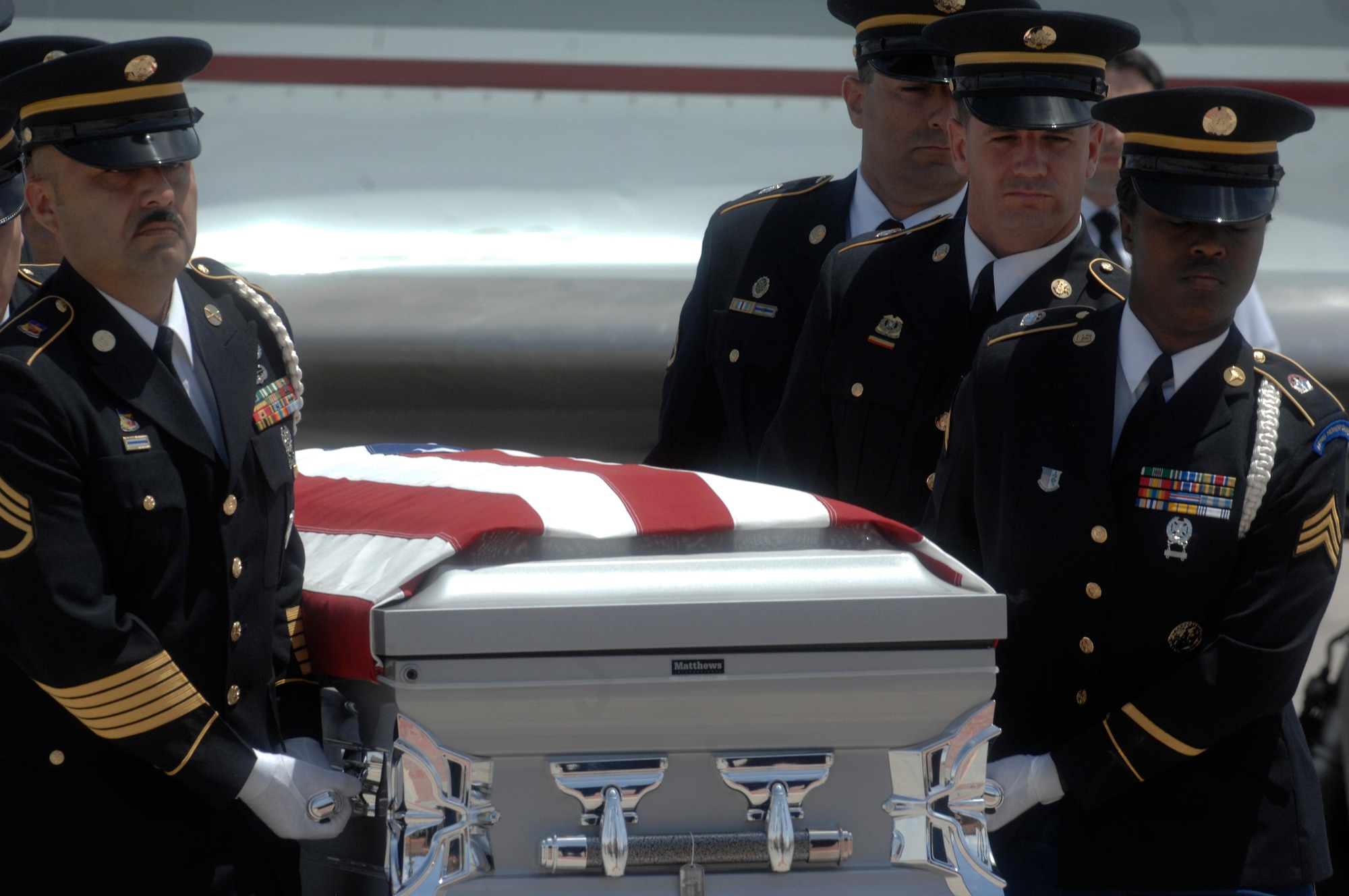 NELLIS AIR FORCE BASE, Nev.-- A U.S. Army pallbearer team transfers the remains of Army Sgt. Ken Hermogino, at Nellis Air Force Base, Nev., May 21, 2011. Sergeant Hermogino died May 9 in Herat province, Afghanistan, of injuries sustained in a non-combat related vehicle accident. Sergeant Hermogino graduated from Basic High School in Las Vegas in 1998 and, prior to transitioning to the U.S. Army in 2009, he served eight years in the U.S. Air Force as a medical administrator. He will be laid to rest with full military honors at the Southern Nevada Veterans Memorial Cemetery in Boulder City. (U.S. Air Force photo/ Master Sgt. Kevin J. Gruenwald) 
