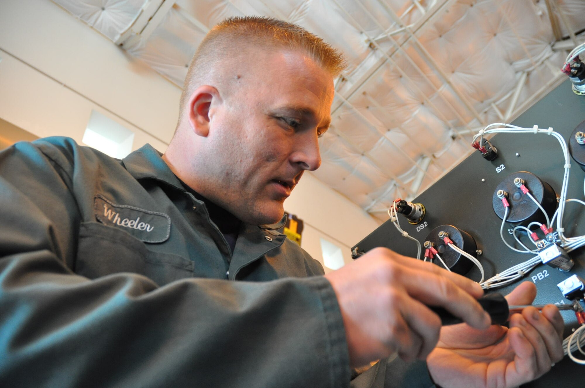 U.S. Air Force Staff Sgt. Brett Wheeler, 446th Maintenance Squadron, powered support systems technician here, works on an Essex B809 diesel generator.  The generator provides power for aircraft on the ground.  Sergeant Wheeler hails from Clarkston, Wash. and is a powered systems technician with the 62nd Maintenance Squadron in his civilian job.  (U.S. Air Force photo by Staff Sgt. Elizabeth Moody)

