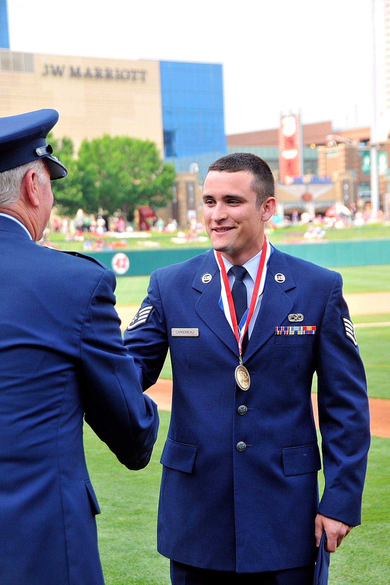 Indiana Air National Guard Staff Sgt. Andrew Carboneau shakes hands with Brigadier General Stewart Goodwin, Assistant Adjutant General - Air, Indiana National Guard, on Victory Field, home of the Indianapolis Indians, in Indianapolis, Ind. on May 20, 2011.  Carboneau was just awarded Airman of the Year for 2010 for the Indiana Air National Guard and was being presented the award at the Armed Forces Day Picnic.  Photo by Indiana Air National Guard Staff Sgt. Justin Goeden. RELEASED