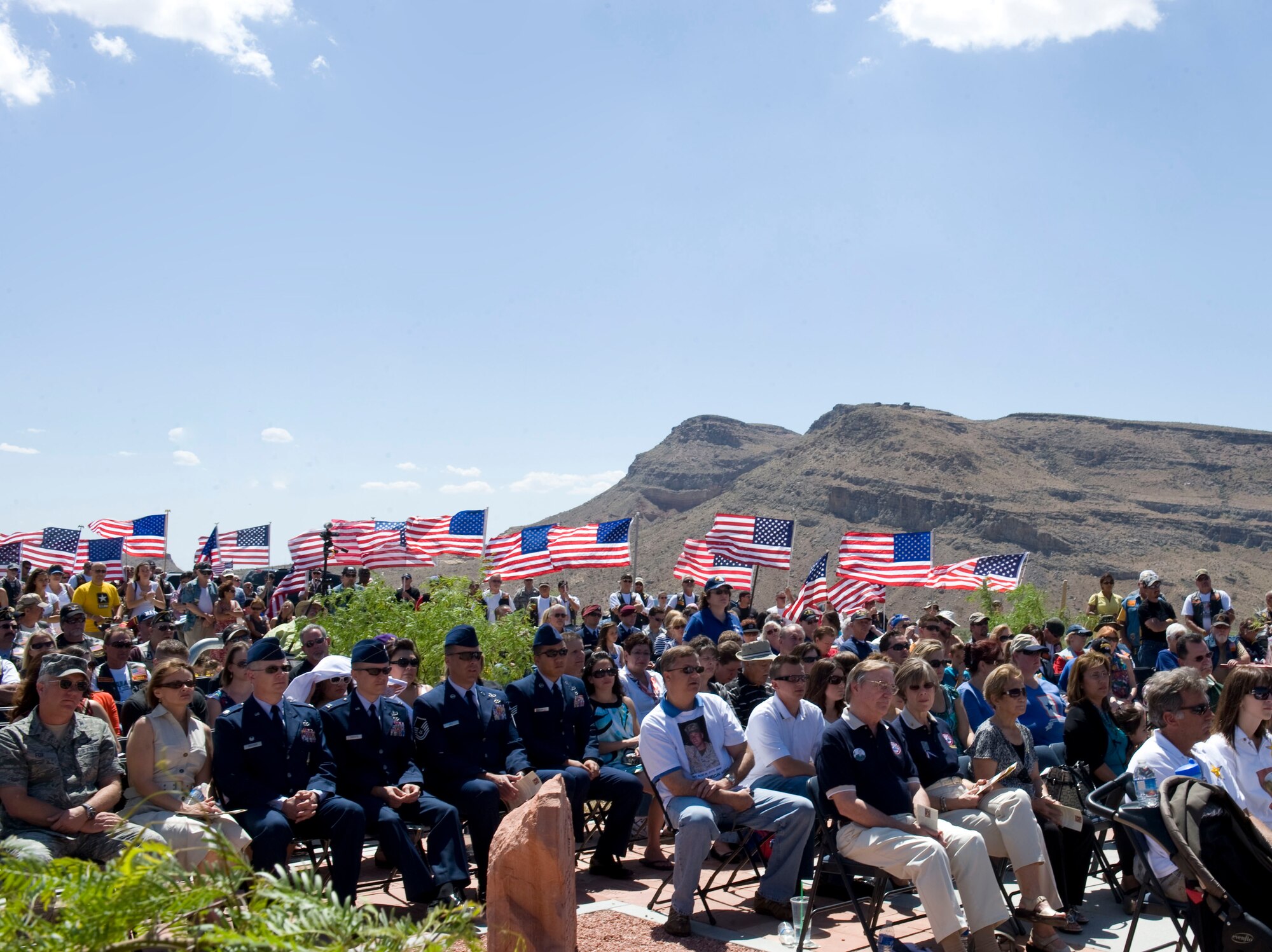 LAS VEGAS -- Attendees listen as guest speakers honor fallen servicemembers with Nevada ties during the 6th annual Defending Freedom Memorial dedication ceremony at the Red Rock National Conservation Area May 14, 2011. The Defending Freedom Memorial was initially dedicated in 2005 and is comprised of seven sandstones with the engraved names of Nevada's fallen servicemen and women. This year, the names Nellis Airmen Senior Airman Michael Buras, Staff Sgt. David Smith, 1st Lt. Joel Gentz and Capt. David Wisniewski were added to the memorial. All four Airmen were lost in 2010 while supporting operations in Afghanistan.  (U.S. Air Force photo by Airman 1st Class Jamie L. Nicley)
