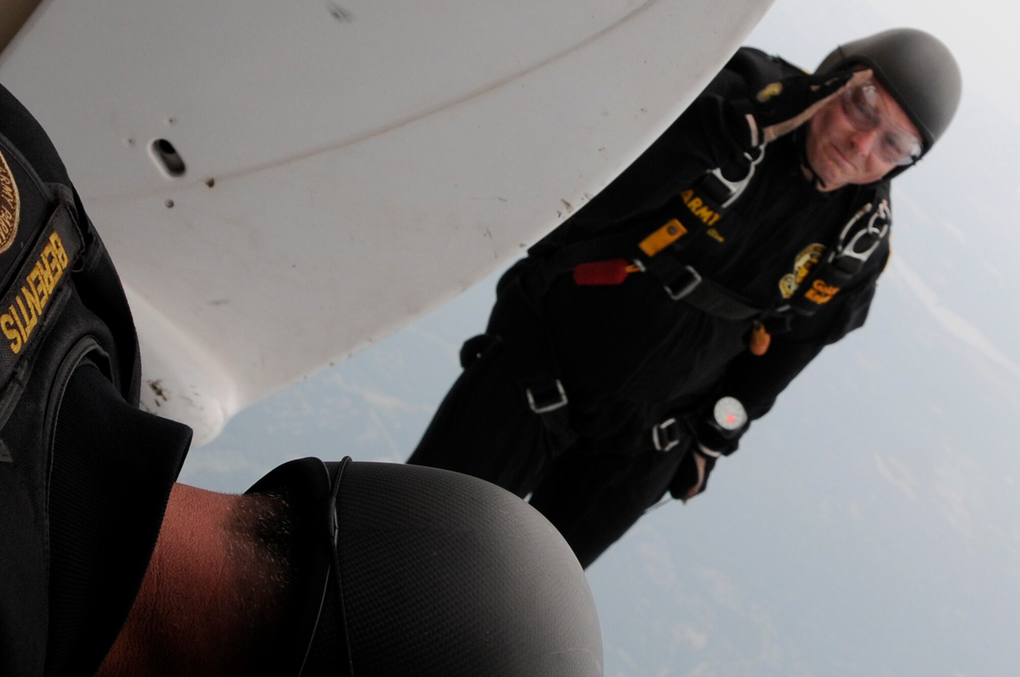 A member of the U.S. Army Golden Knights salutes his fellow jumpers as he descends 11,500 feet to the ground. The Golden Knights performed at the 2011 Joint Service Open House May 20 to 22. The JSOH affords the public an opportunity to meet the men and women of the Armed Forces and to see the military equipment from the Navy, Marines, Army, Air Force and Coast Guard. The JSOH is a planned and conducted through the efforts of active duty, guard and reserve servicemembers, as well as civilian employees, retirees and family members. (U.S. Air Force photo by Airman 1st Class Tabitha N. Haynes) 