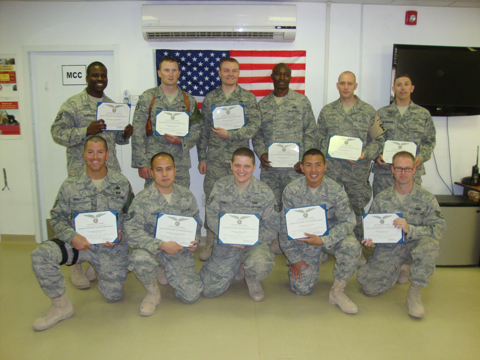 Master Sgt. Robert W. Grimsley, bottom row left, poses after being awarded the Military Outstanding Volunteer Service Medal April 13, 2011 for his volunteerism and support with the 332nd Expeditionary Medical Group in Iraq. Sergeant Grimsley is the flight chief for the 315th Airlift Wing Security Forces Squadron at Joint Base Charleston, S.C. (U.S. Air Froce Photo by Staff Sgt. Shane Ellis)