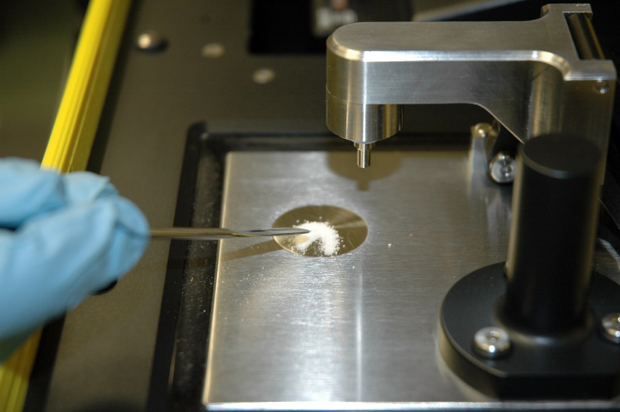 U.S. Air Force Capt. John Lever, 446th Aerospace Medicine Squadron, bioenvironmental engineer out of McChord Field, Wash., analyzes a powdery substance with a hi-tech portable HAZMATID unit. HAZMATID bombards an unknown solid or liquid with infrared radiation and uses a database of 5,000 chemical makeups to identify a substance placed on it, delivering fast, dependable on-site analysis in the field.  Bioenvironmental engineers can use these to provide incident commanders with immediate laboratory test results they can then use to make decisions that save lives.  (U.S. Air Force photo by Staff Sgt. Elizabeth Moody/Released)