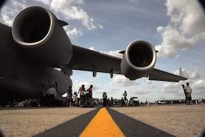 Visitors at the 2011 Joint Service Open House seek shade under the massive shadow cast by a C-17 Globemaster III here May 21.  The JSOH affords the public an opportunity to meet the men and women of the Armed Forces and to see military equipment from the Navy, Marines, Army, Air Force and Coast Guard. The JSOH is planned and conducted through the efforts of active duty, guard and reserve servicemembers, as well as civilian employees, retirees and family members.(U.S. Air Force photo by Senior Airman Torey Griffith)