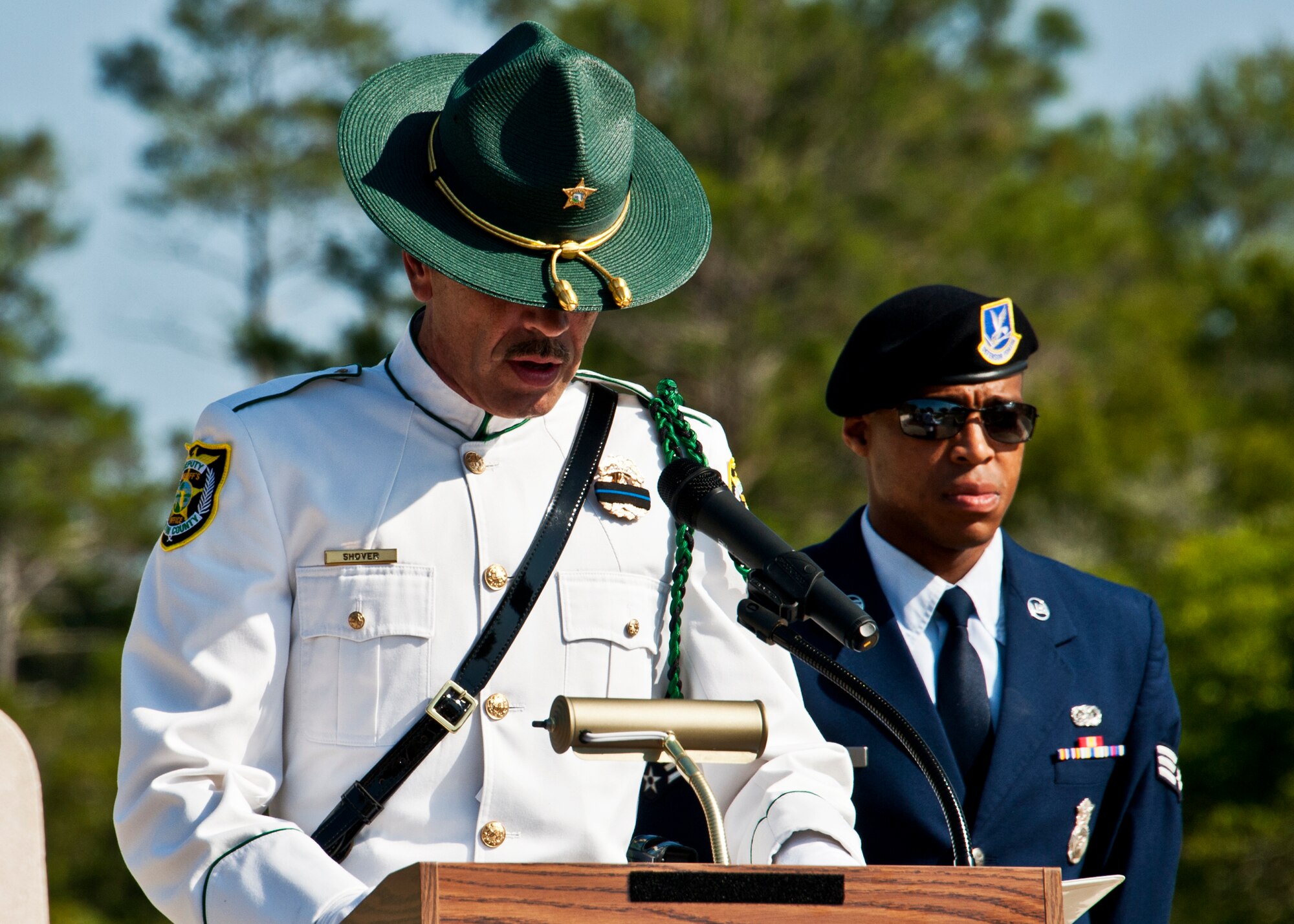 Walton County Sheriff Deputy Harold Shover, reads off the names of law enforcement personnel who’ve fallen in the line of duty prior to a Retreat ceremony at Eglin’s All Wars Memorial May 20.  The ceremony closed out a week of activities by base security forces and local law enforcement in celebration of National Police Week.  (U.S. Air Force photo/Samuel King Jr.)